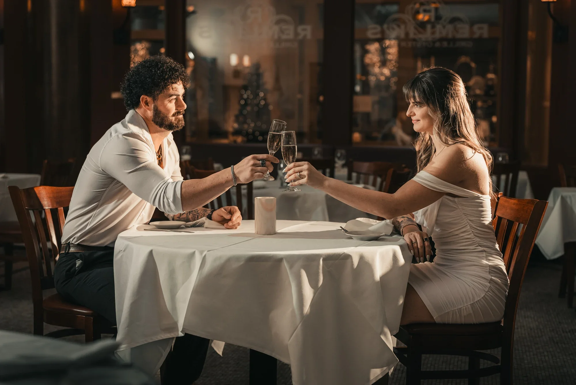 Kari and Josh raise their glasses in the Remlik’s dining room during their engagement session.
