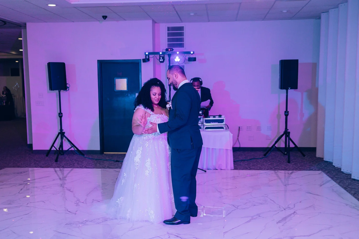 Christina and Erick’s first dance on the ballroom floor under purple uplighting