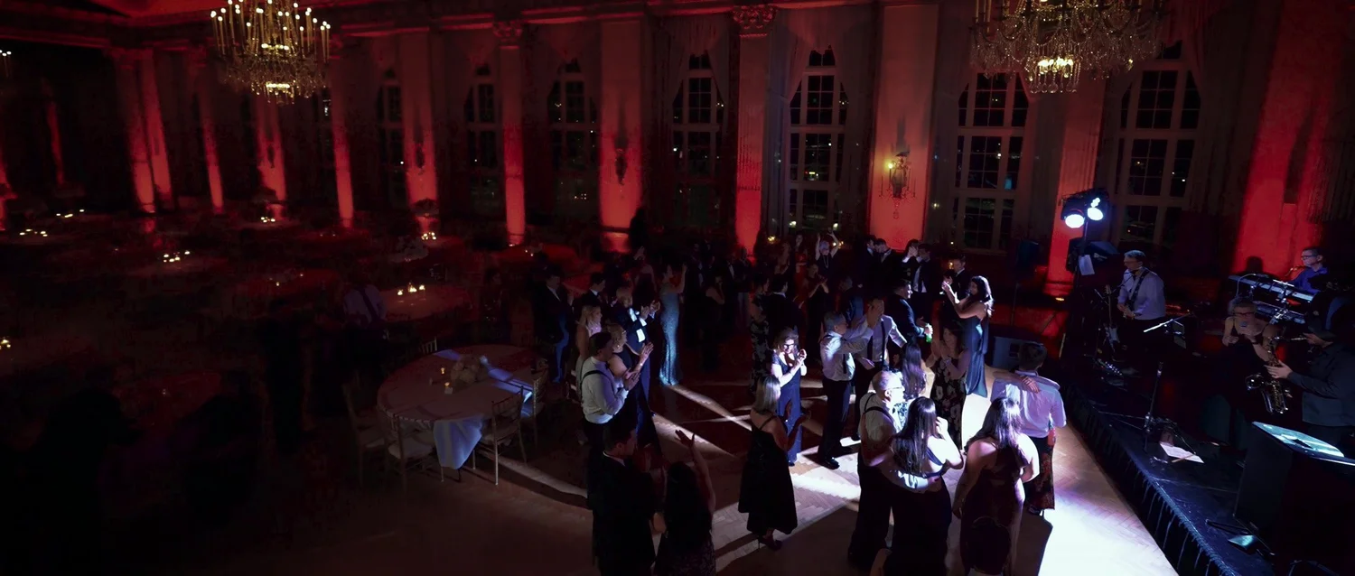 Guests celebrating in a chandelier-lit ballroom at Marriott Syracuse Downtown