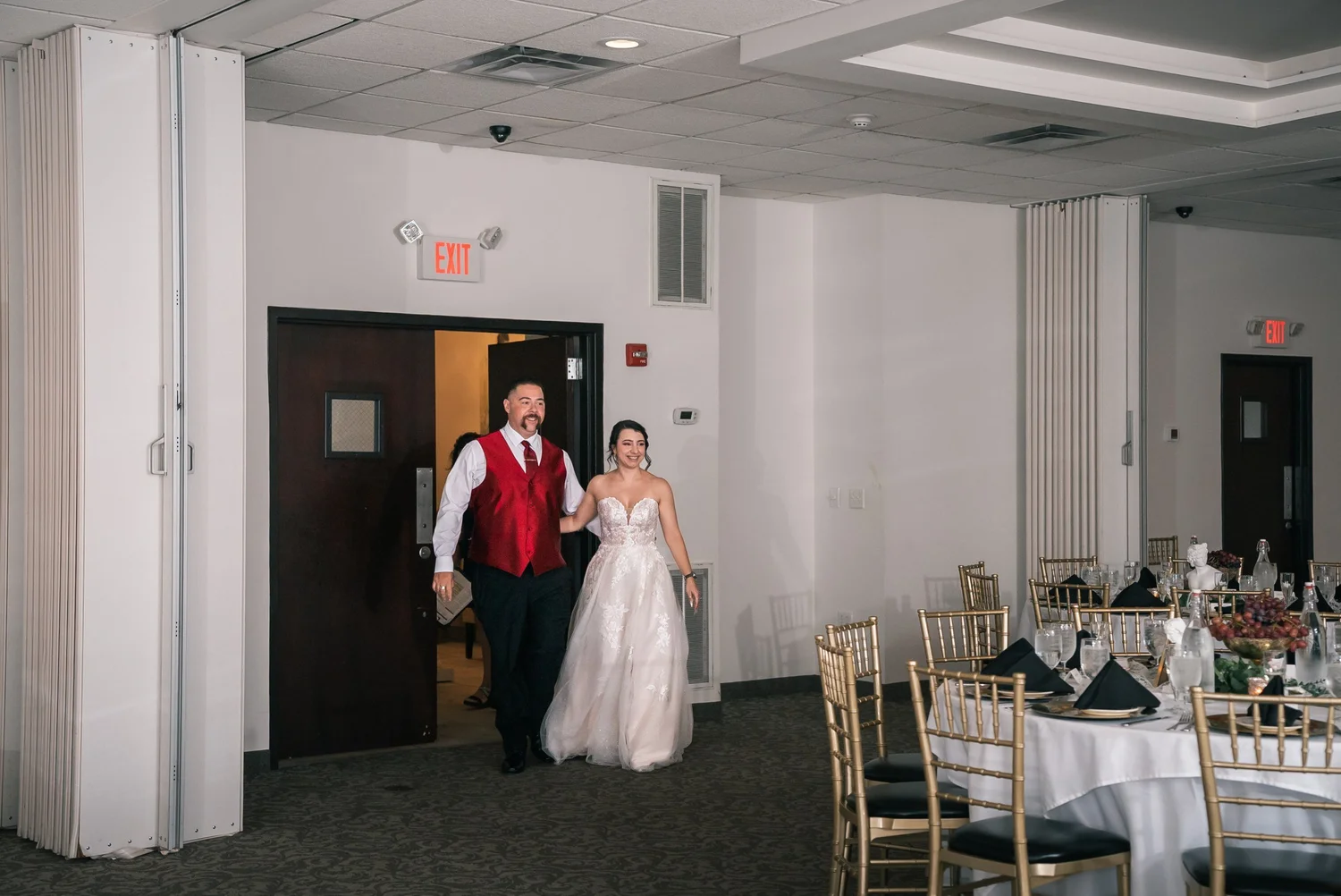 Laura and Dante walking into the ballroom for their grand entrance