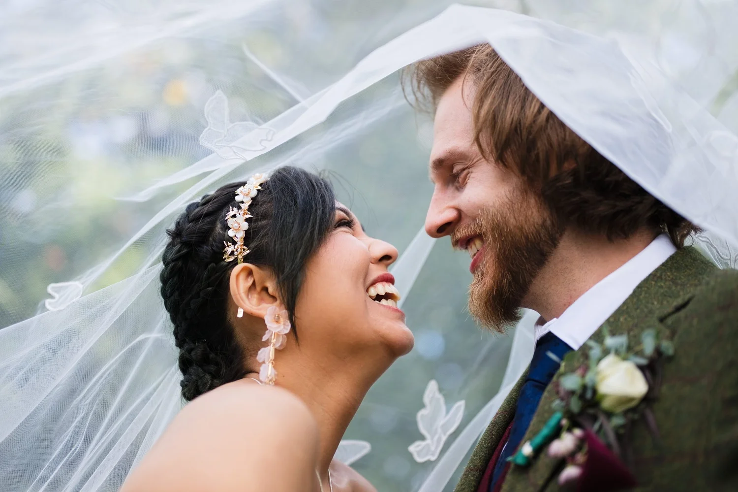 Marseille laughing up at Jason with her veil drifting over both of them