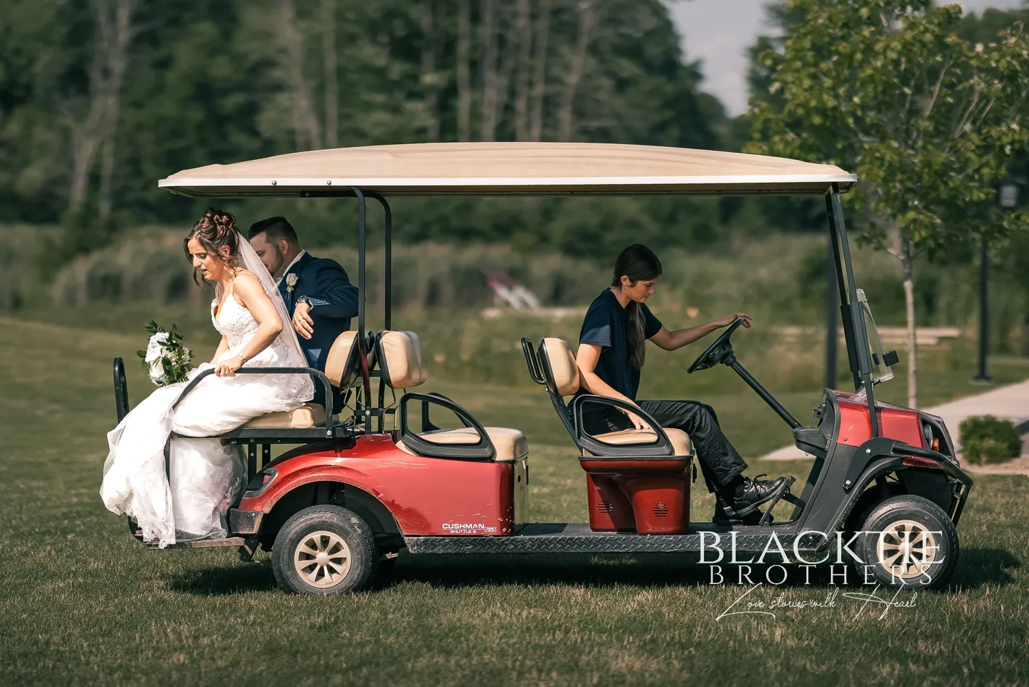 Taylor and Jake riding in a red golf cart across the course, her dress spilling over the side, a staff member driving