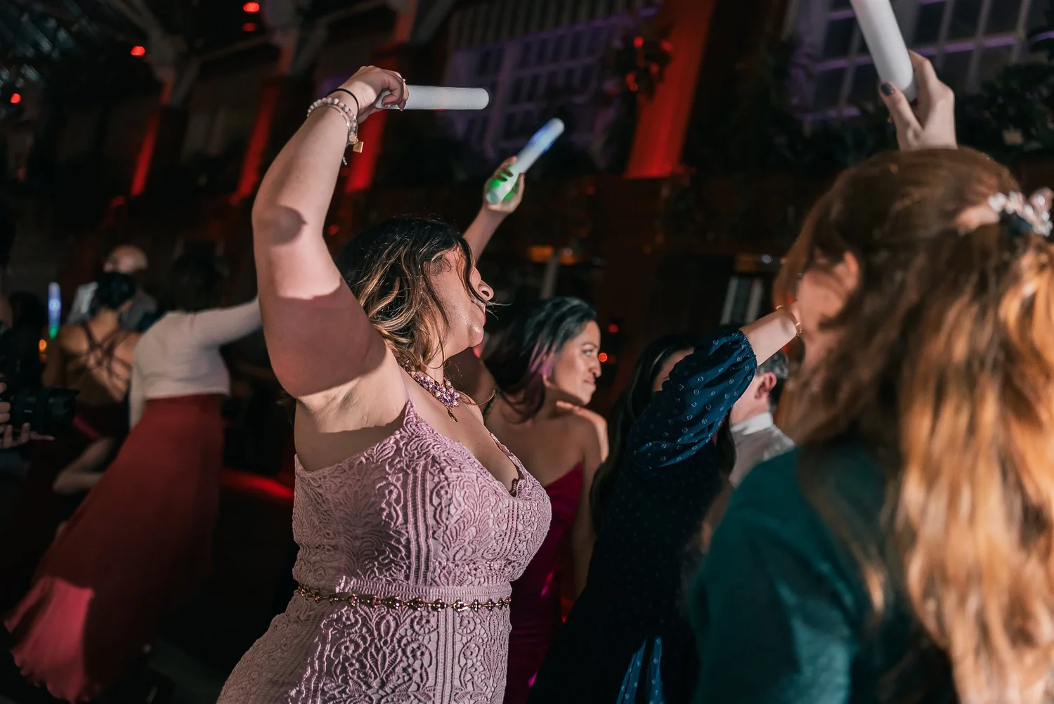 Guests raise light sticks and dance together during Patricia and Joshua’s reception at The Somerley.