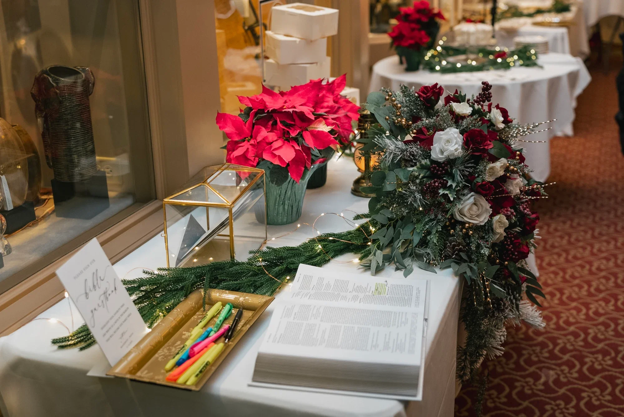 Poinsettias, a card box and a guest book on the gift table at Remlik’s.