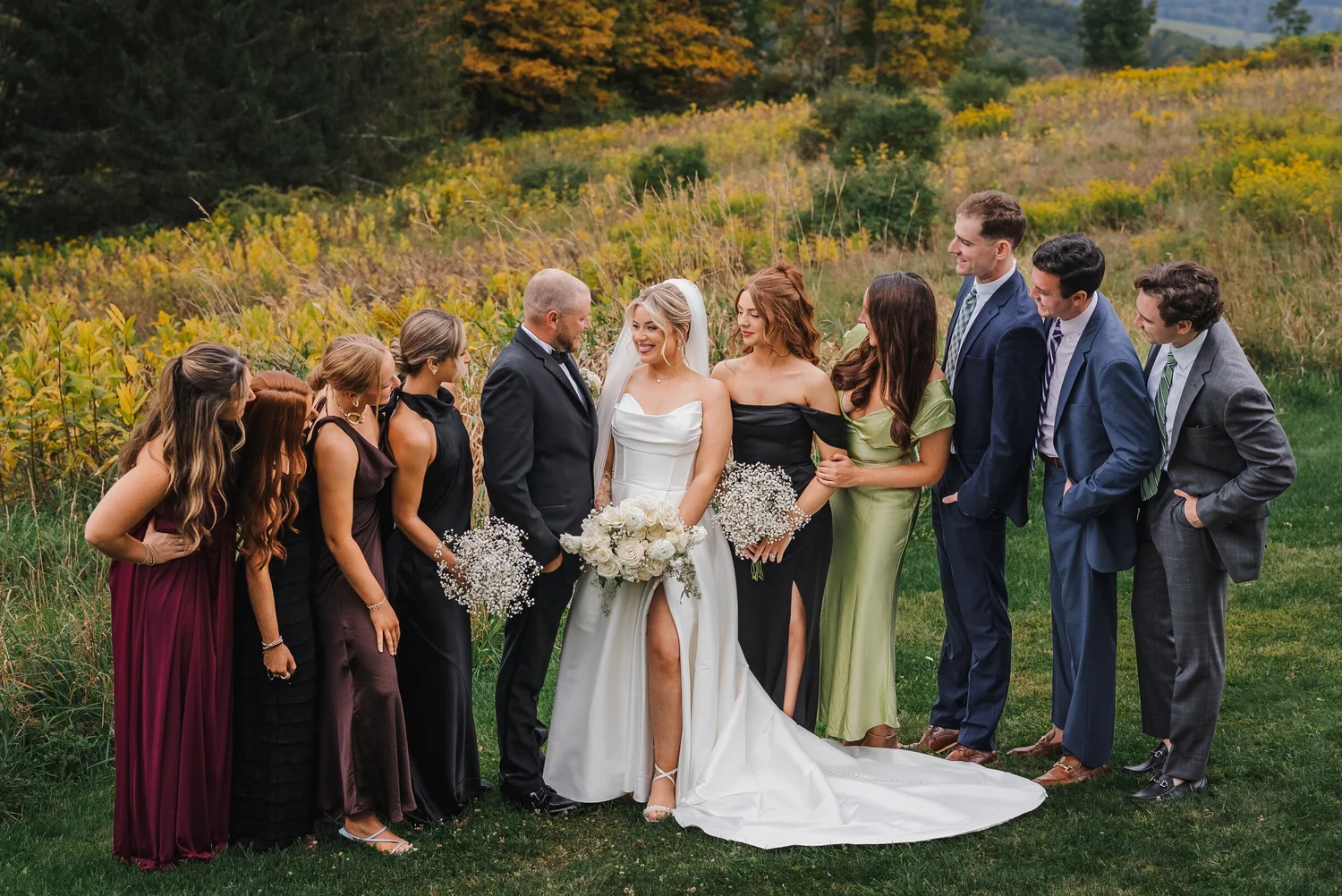 Wedding party posing with autumn fields and Catskill views at Stonewall Estate