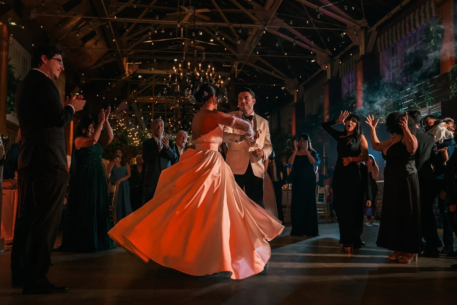 Patricia turns across the dance floor with Joshua beneath the chandeliers at The Somerley.