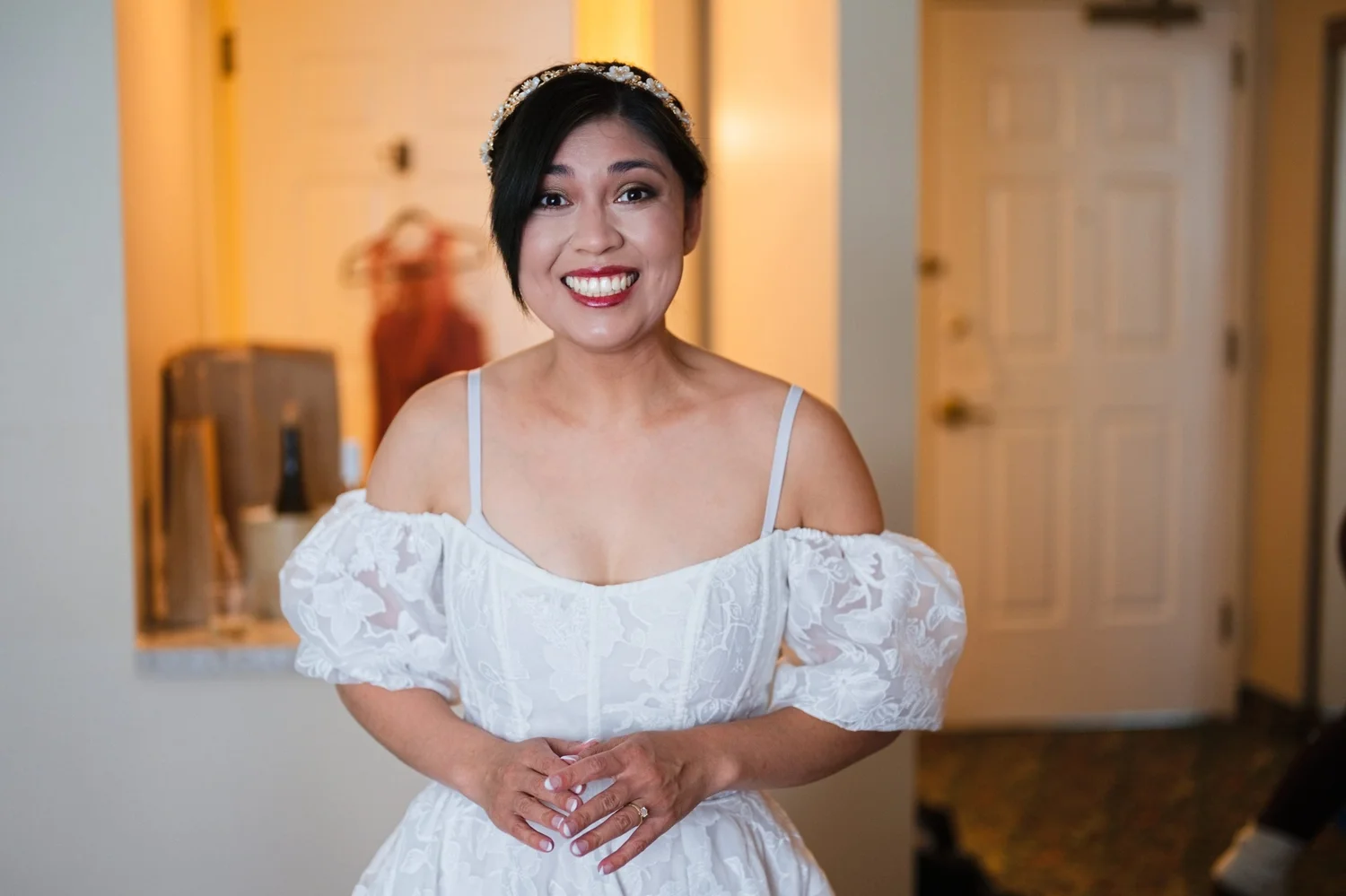 Marseille beaming in her off-the-shoulder dress and jeweled hairpiece while getting ready