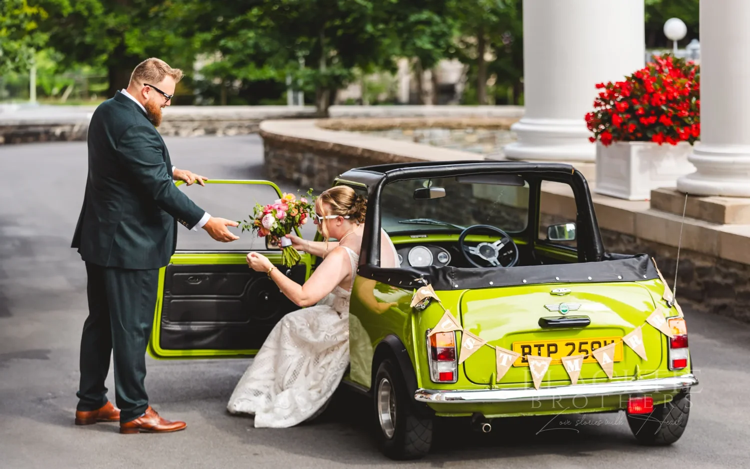 Chris helping Amanda into a green Mini Cooper convertible at The Otesaga entrance