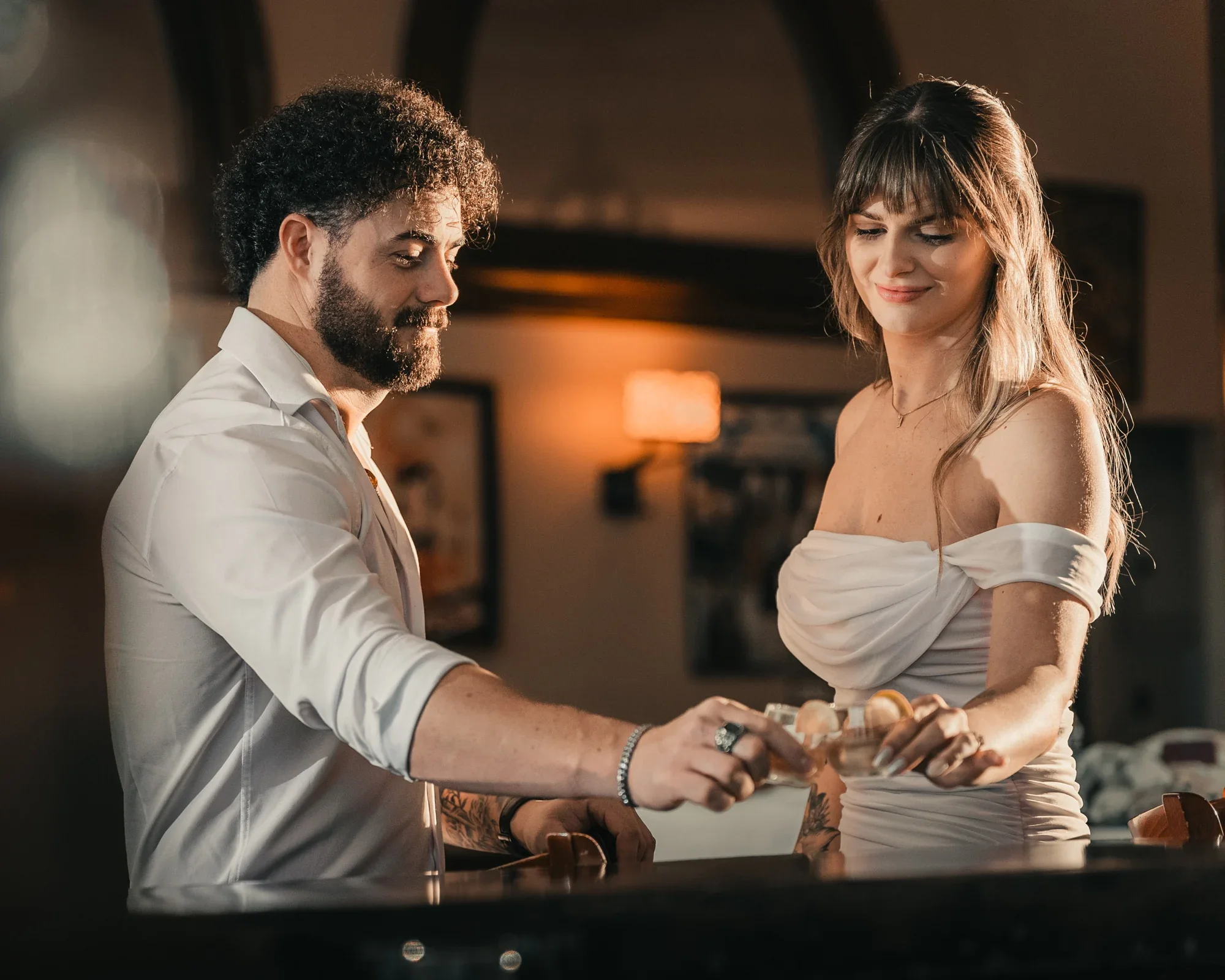 Kari and Josh clink cocktails at the bar during their Remlik’s engagement session.