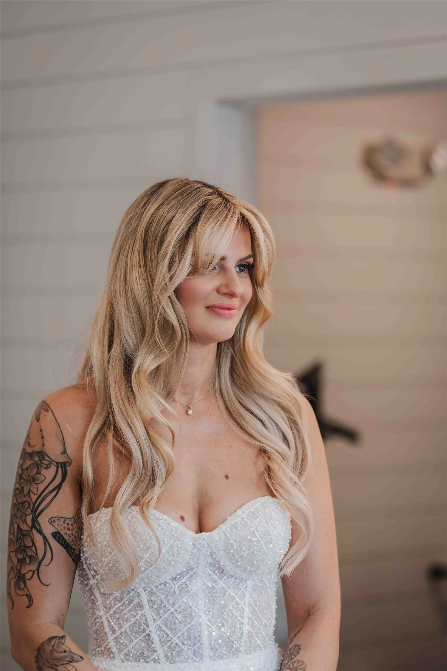 Kari in her wedding dress, photographed against the pale walls of the getting-ready room.