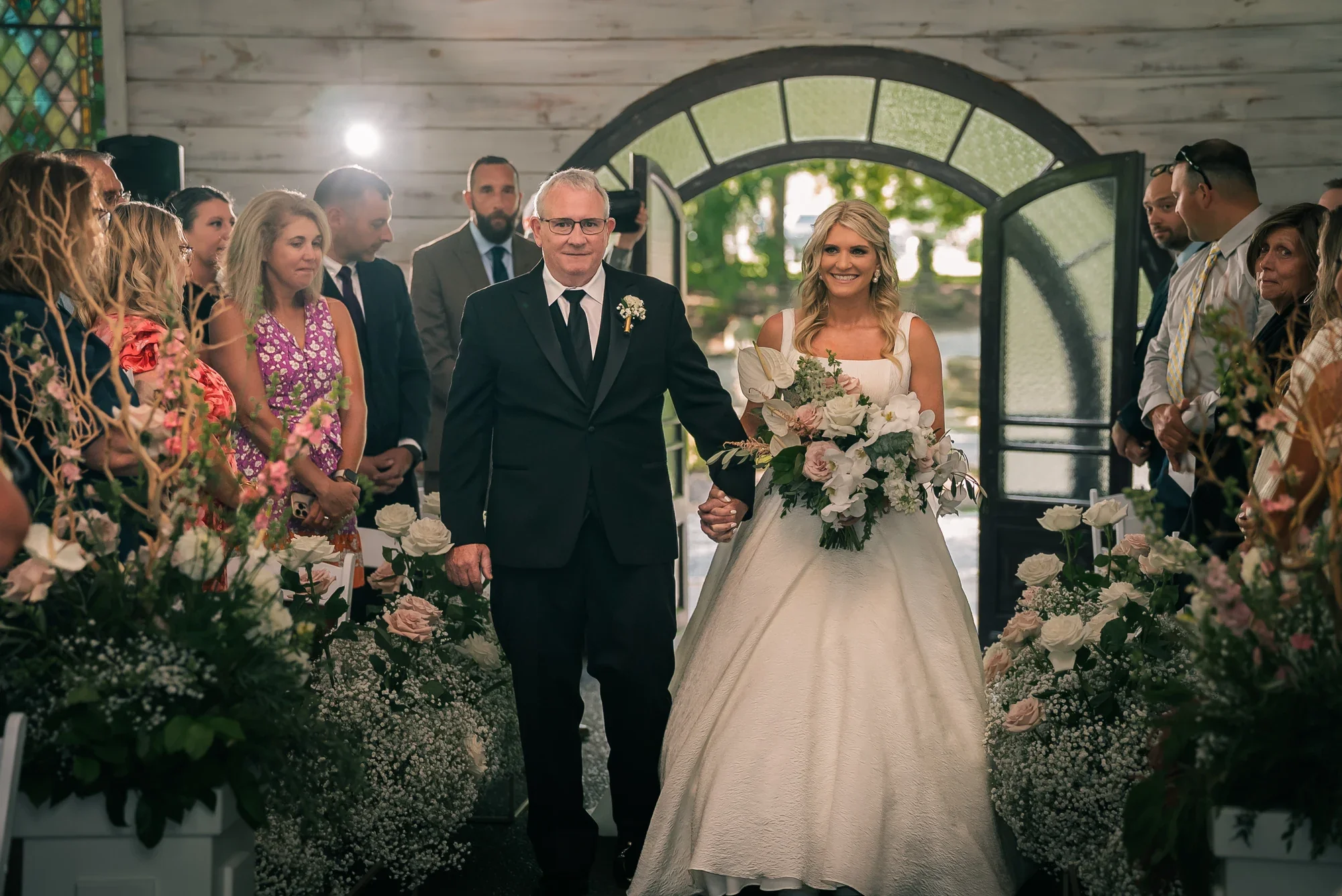 A bride enters the Chapel in the Woods at Graceful Gatherings at LedgeRock.