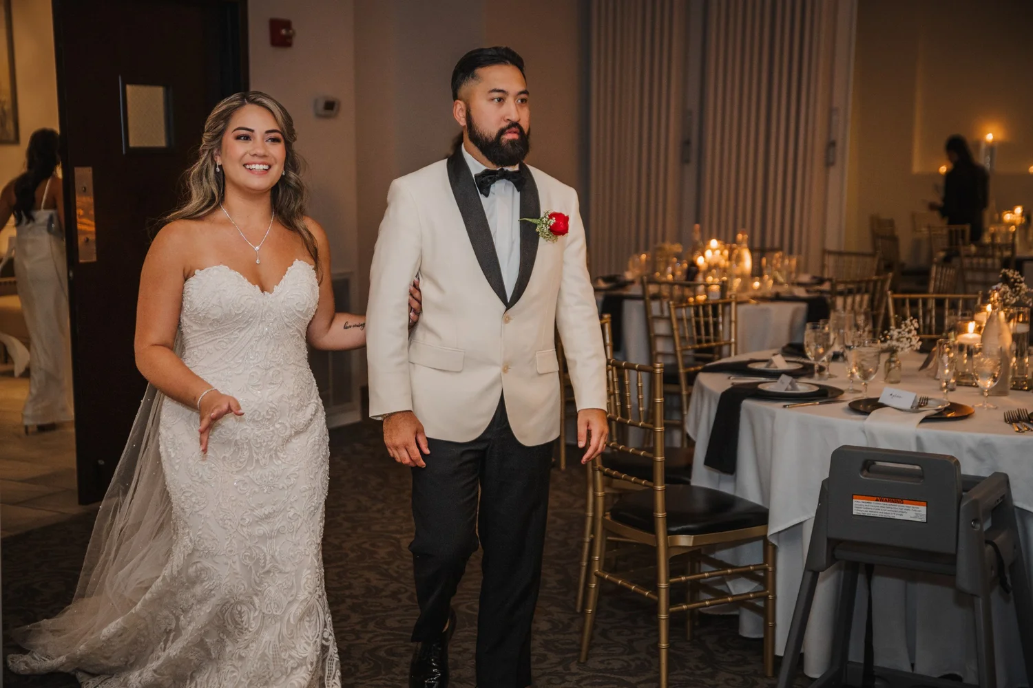 Alice and Mitchell seeing their candlelit reception room for the first time before guests come in