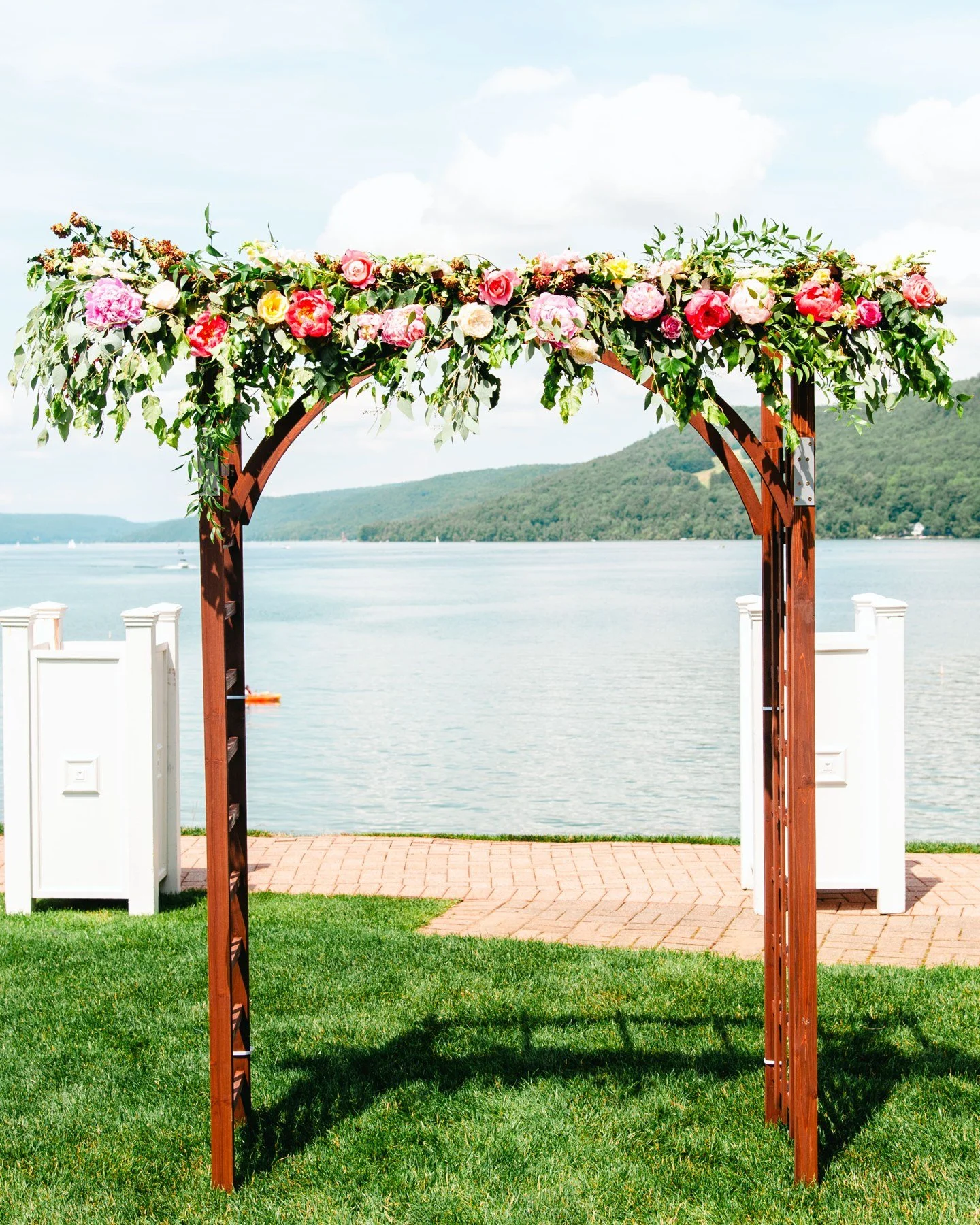 Floral ceremony arbor facing Otsego Lake at The Otesaga