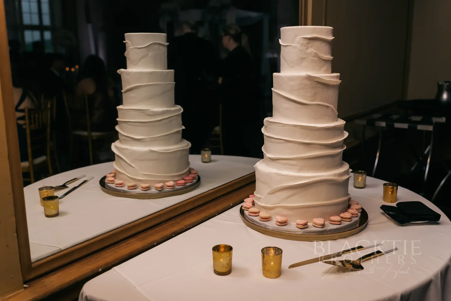 Two white tiered wedding cakes at the reception at Marriott Syracuse Downtown