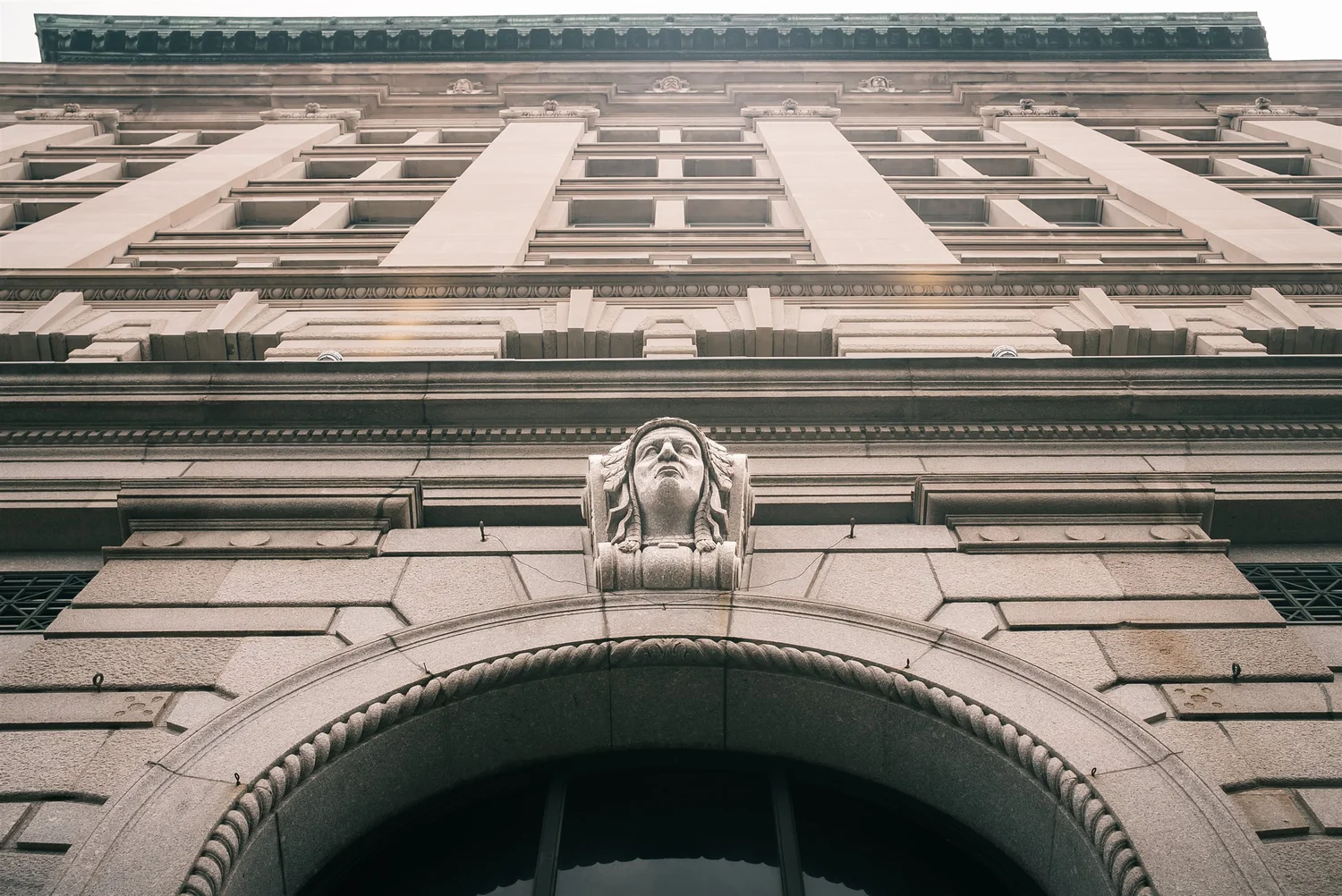 The Treasury facade above the arched entrance in Syracuse.