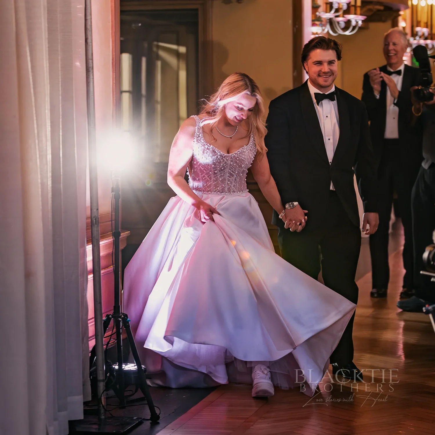 Catie twirling as she and Brad enter their wedding reception at Marriott Syracuse Downtown
