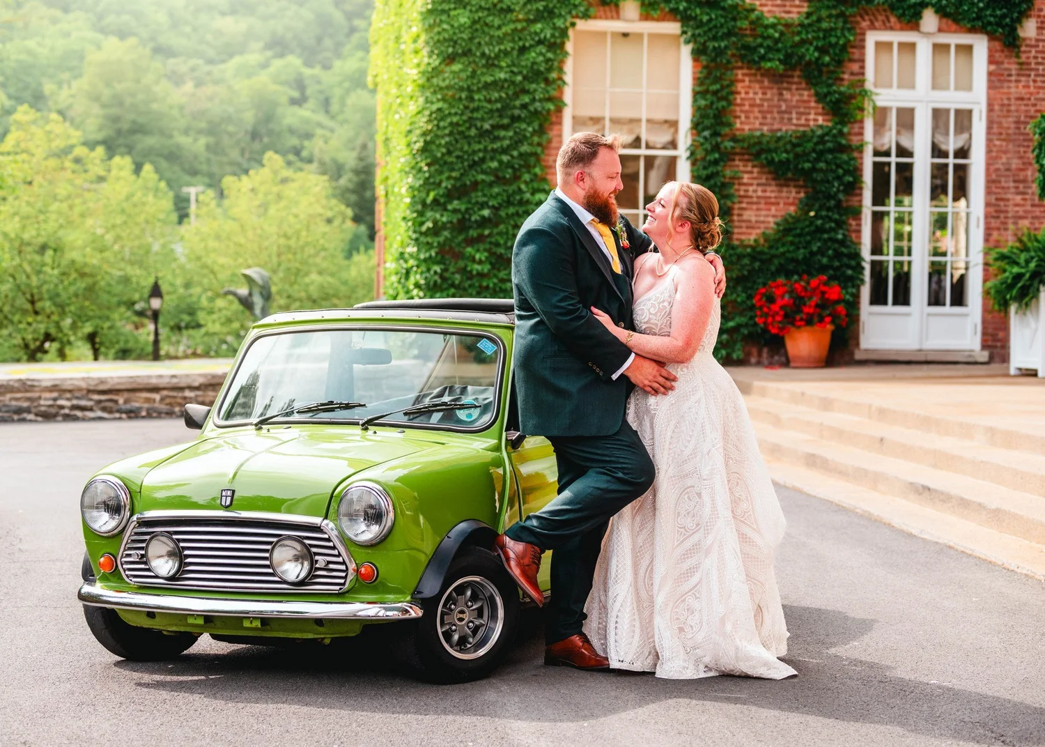 Amanda and Chris beside a green Mini Cooper at The Otesaga entrance