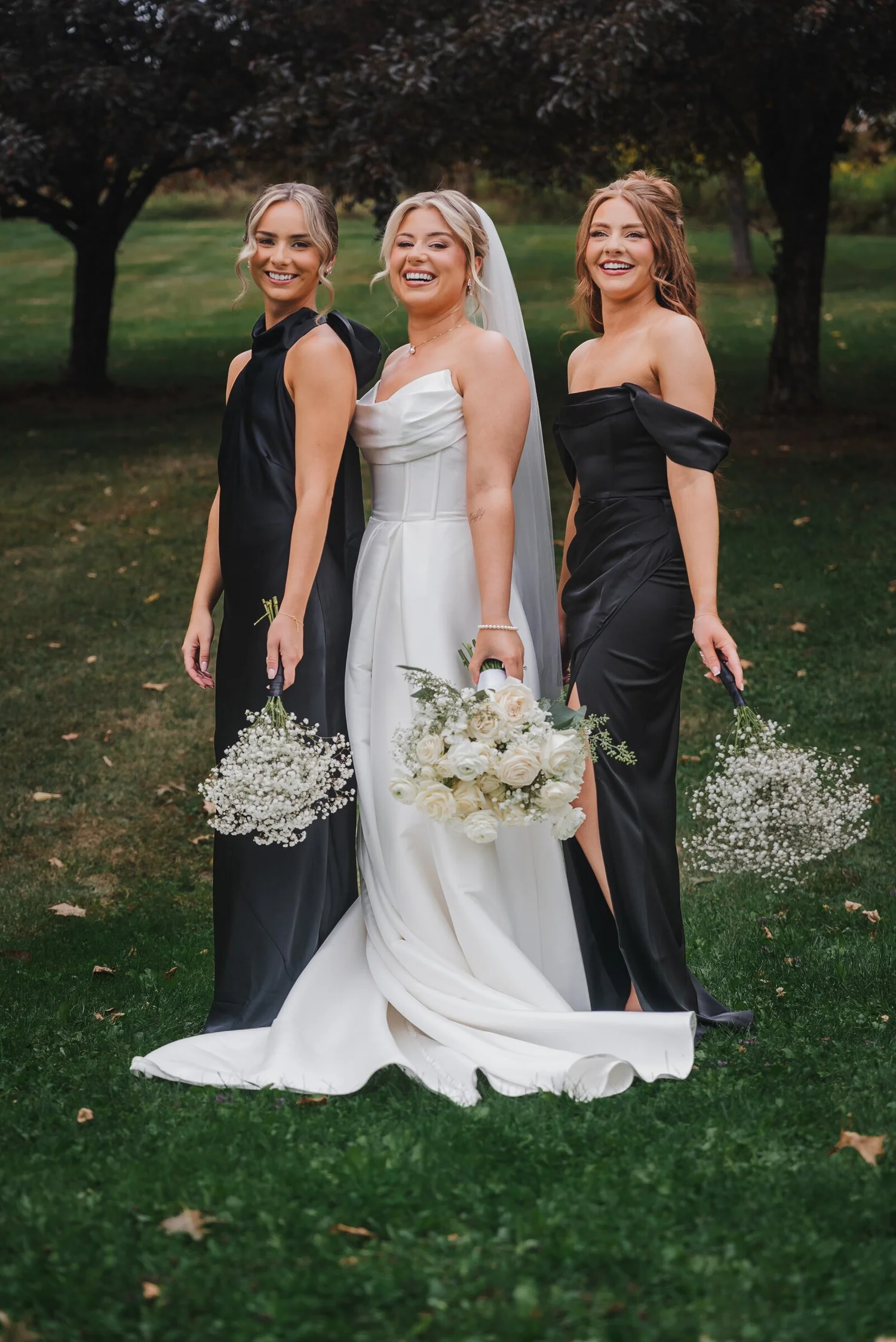 Bride posing outdoors with two bridesmaids before the ceremony