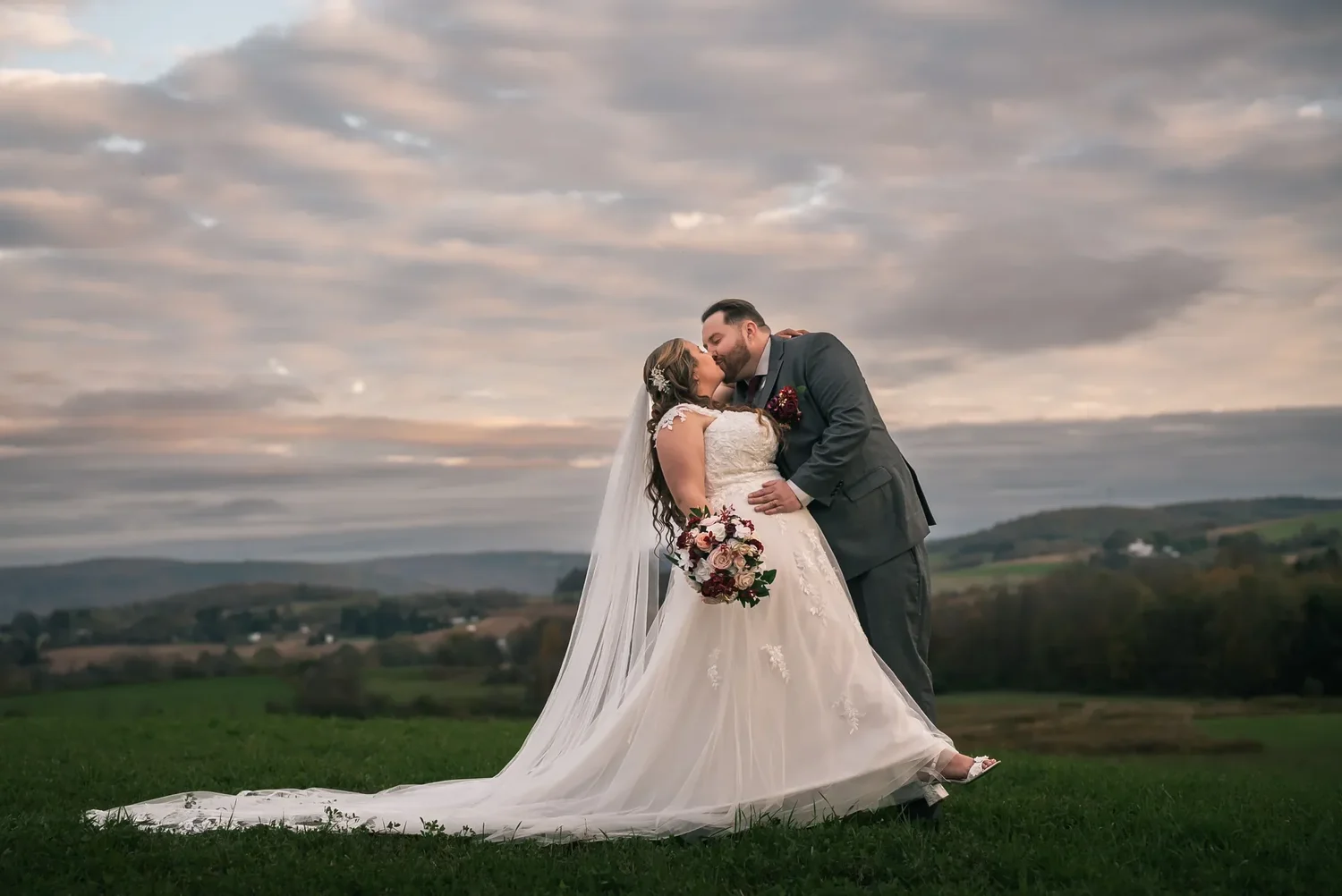 Newlyweds photographed against the Central New York landscape at Stoney Creek Castle