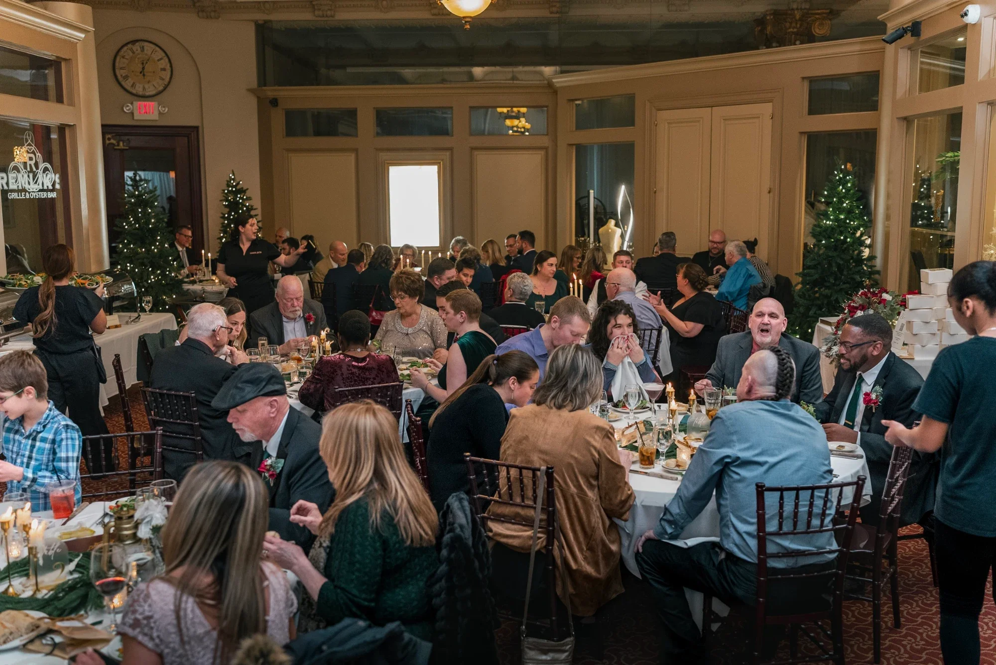 Wide view of the Remlik’s dining room filled with guests at Mackenzie and David’s reception.