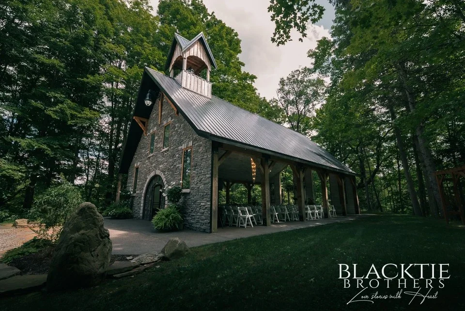 The open sided Chapel in the Woods at LedgeRock, set with white chairs for a ceremony.
