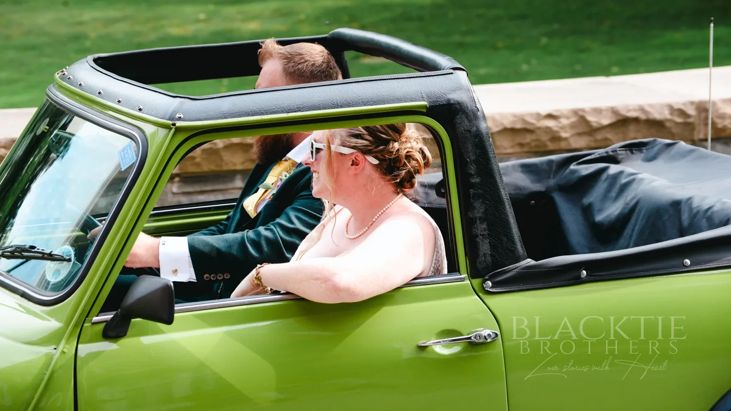 Amanda and Chris riding in the green Mini Cooper convertible at The Otesaga