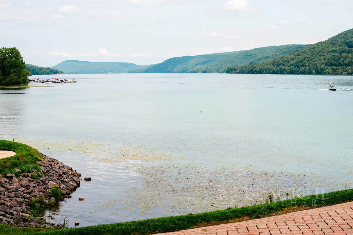Otsego Lake and the surrounding hills seen from the shore at The Otesaga in Cooperstown
