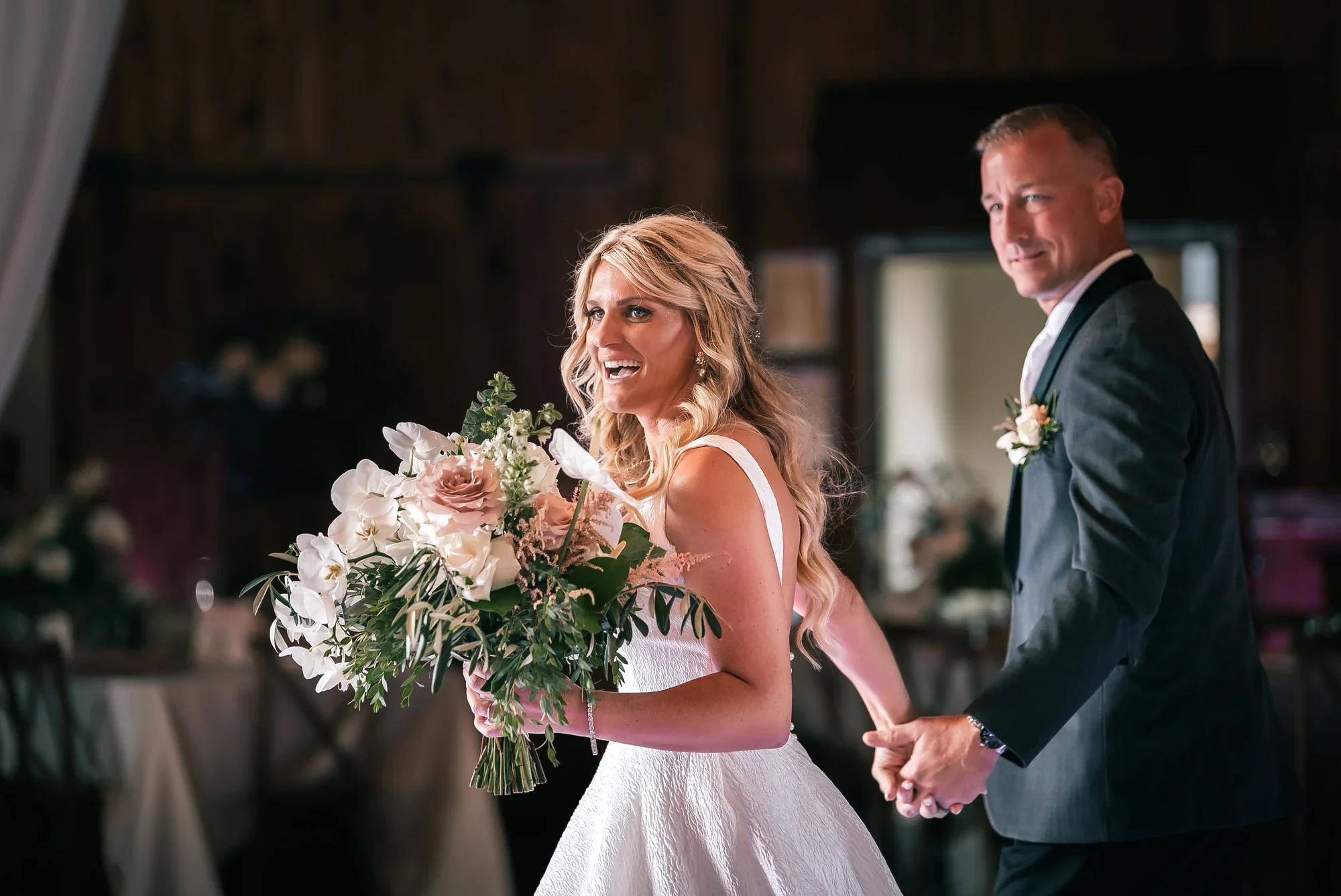 Couple entering the renovated barn reception at Graceful Gatherings at LedgeRock.