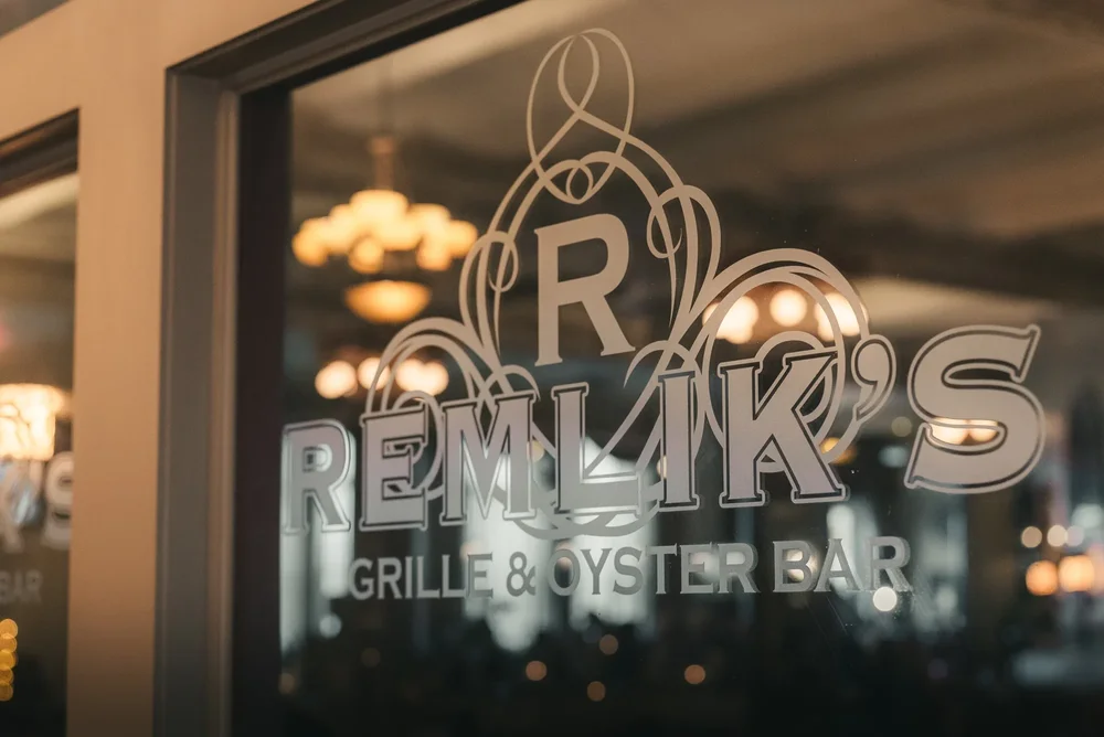 Remlik’s Grille & Oyster Bar lettering on the etched glass entrance in downtown Binghamton, New York