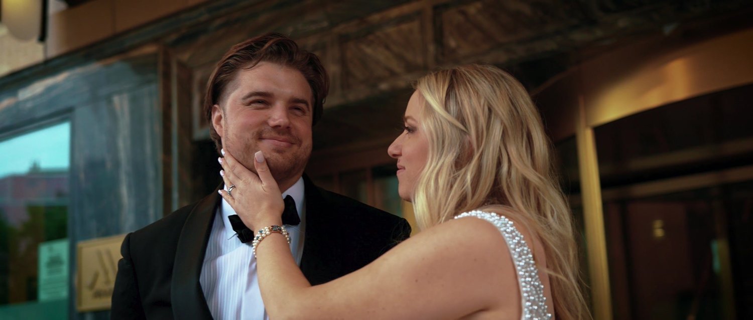 Catie and Brad smiling together during their wedding reception