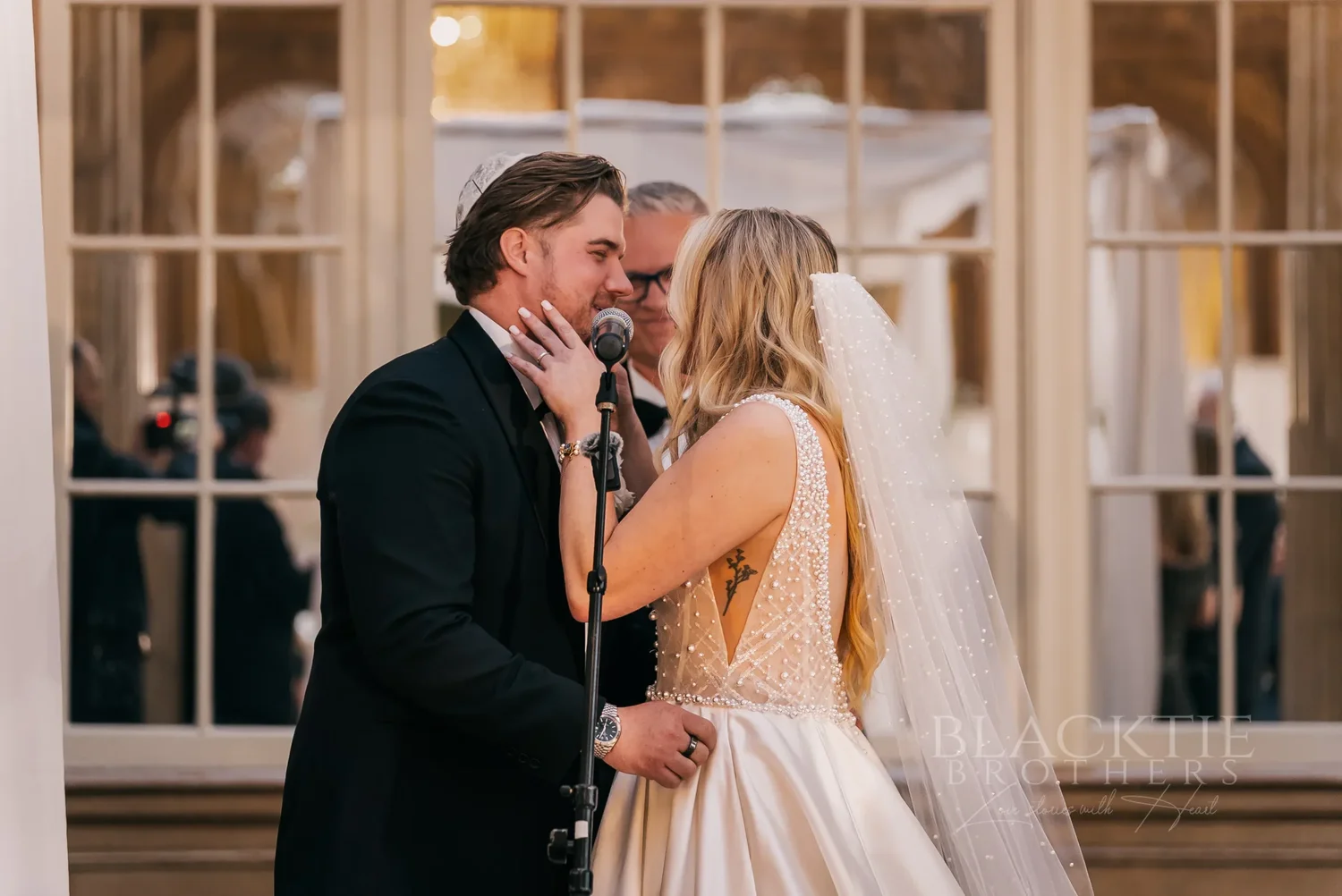 Catie and Brad sharing a moment during their wedding ceremony at Marriott Syracuse Downtown