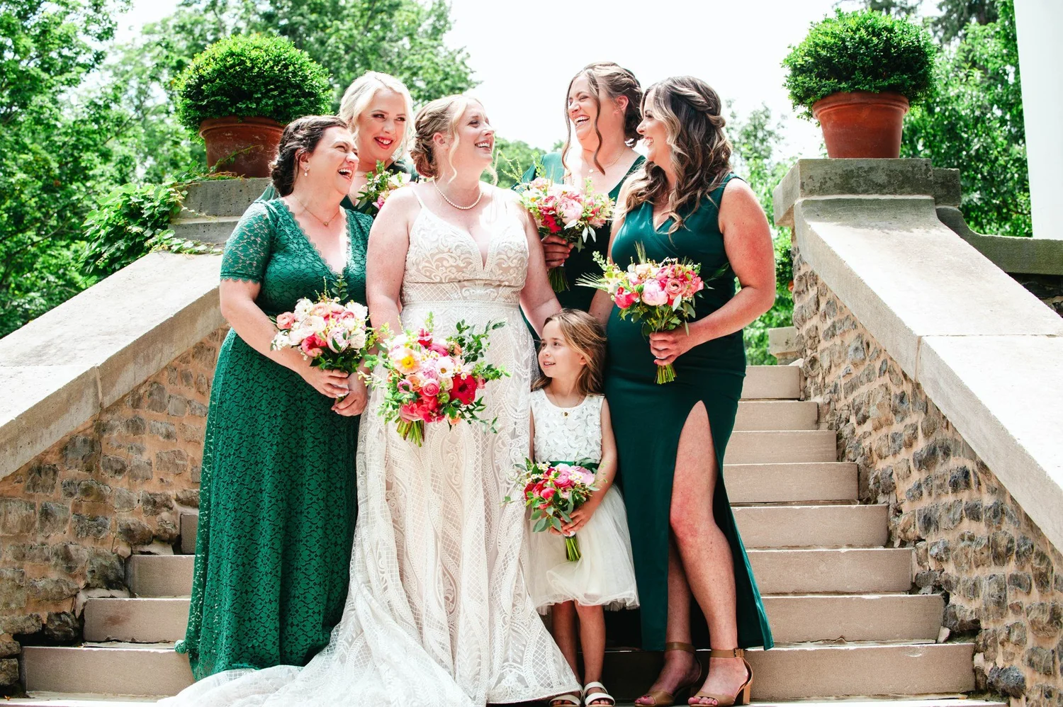 Amanda with bridesmaids on the outdoor steps at The Otesaga