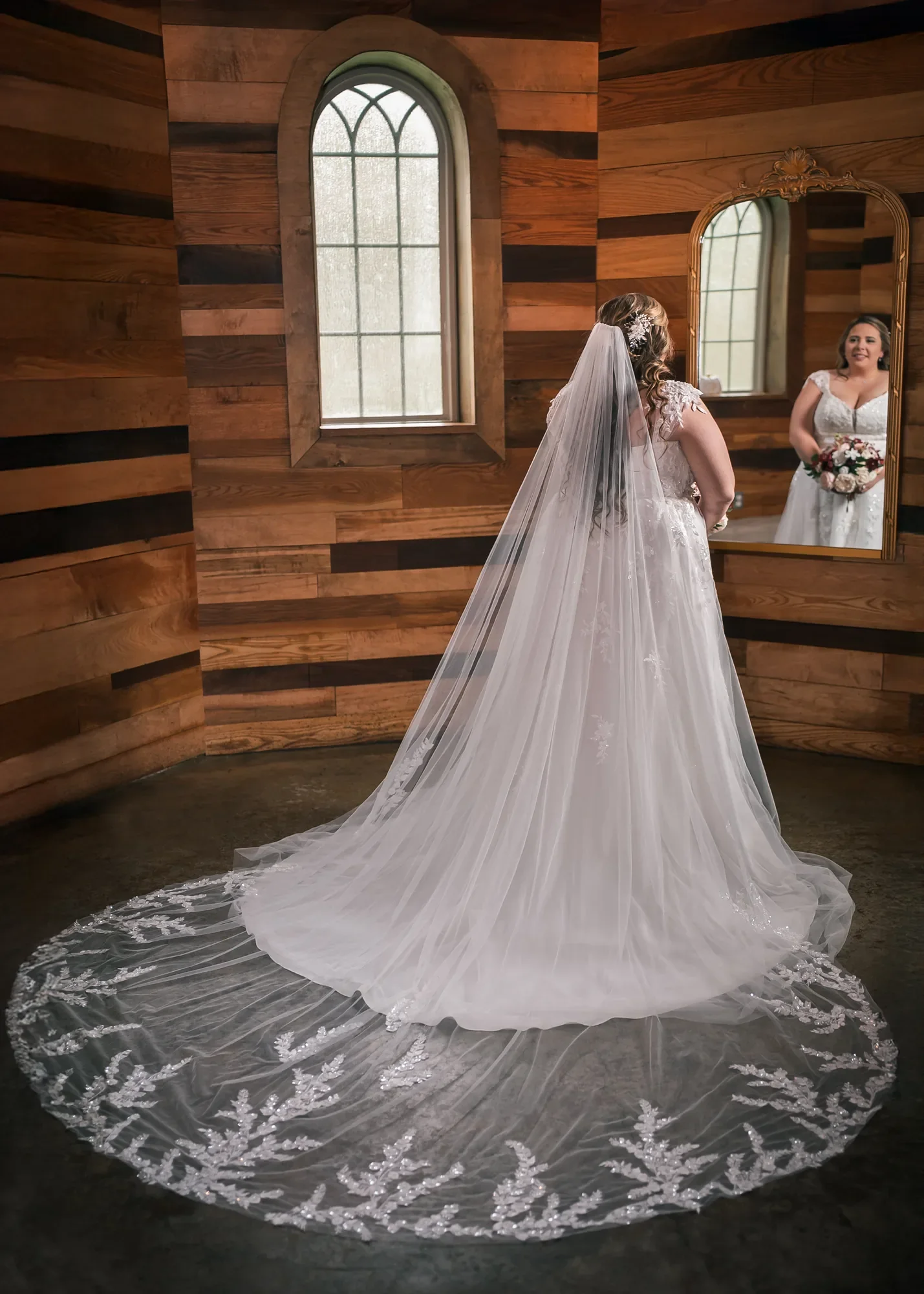 Bride in a wedding dress inside a wood-lined preparation space at Stoney Creek Castle