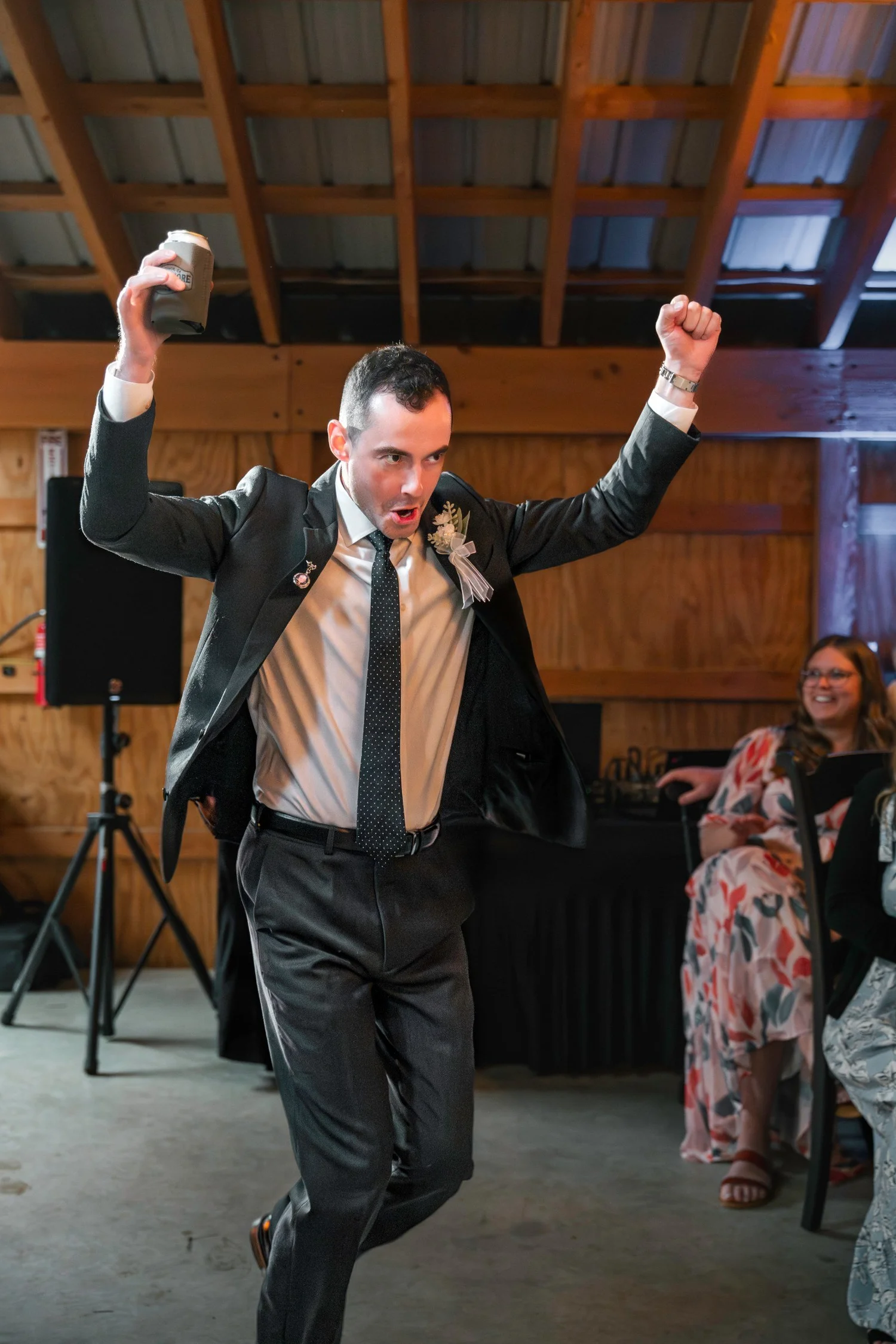 Noah jumping on the dance floor with one arm in the air