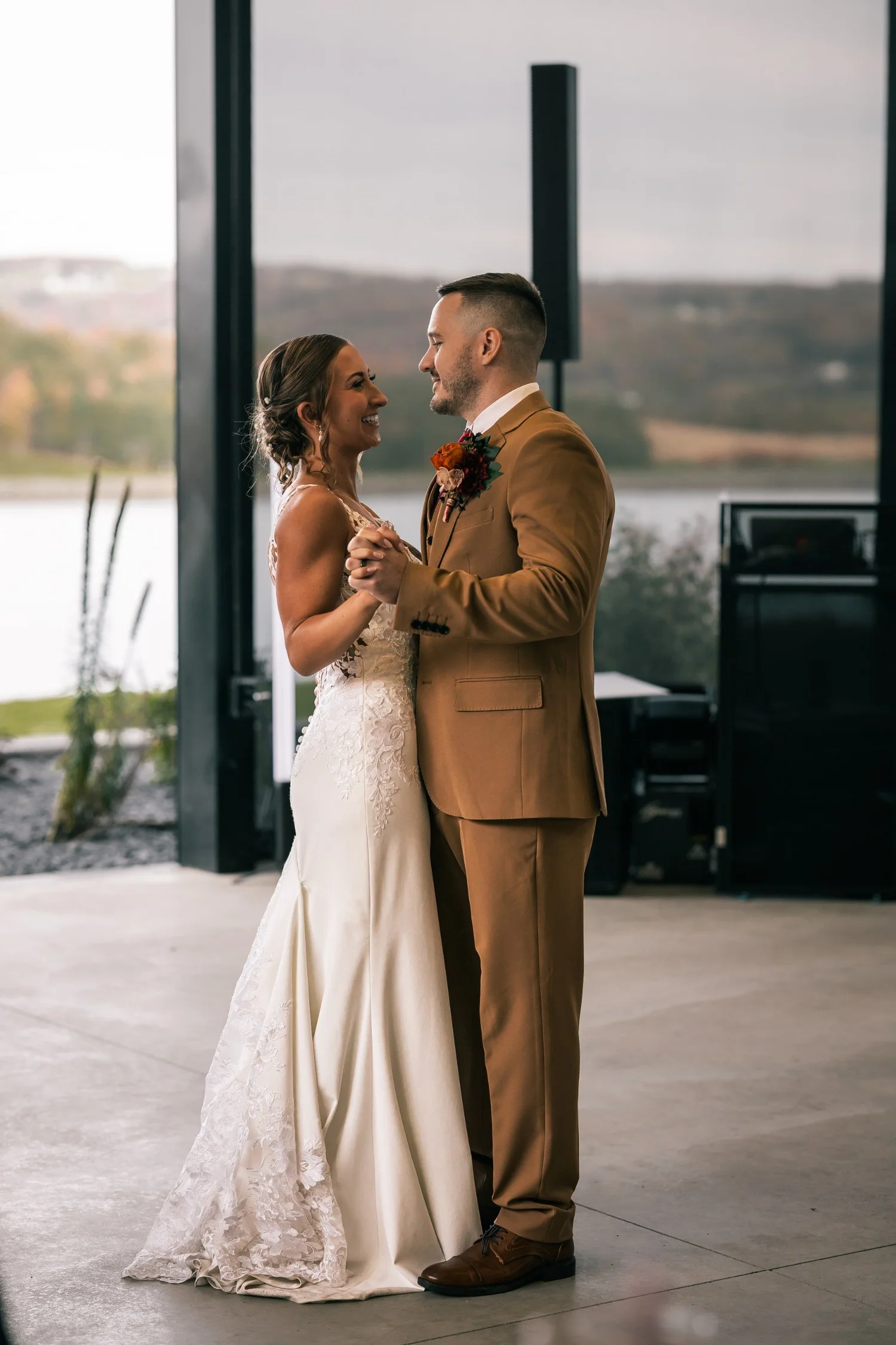 Heather and Vincent’s first dance in front of the pavilion’s tall windows, the pond outside