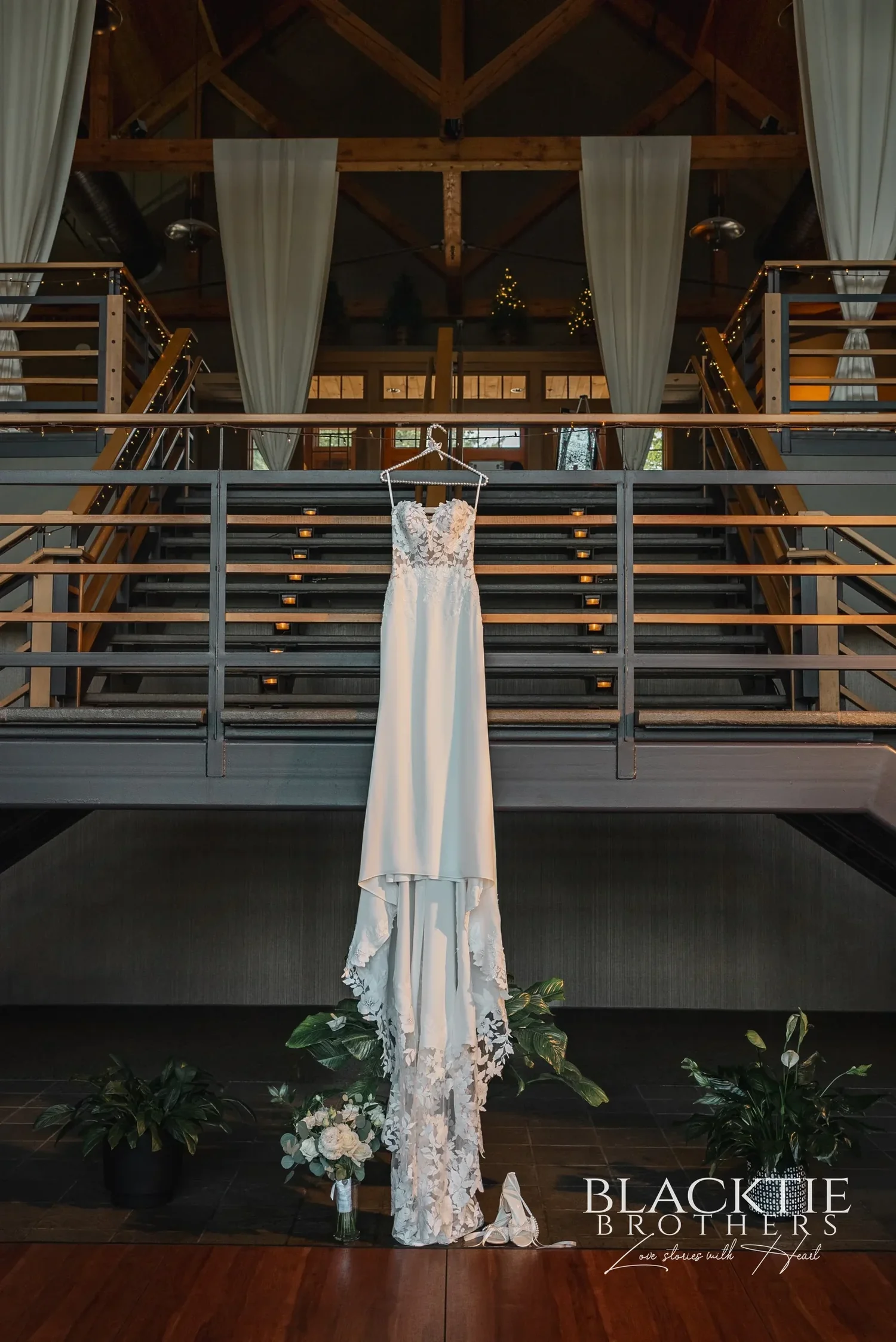 A wedding dress hanging from the mezzanine railing inside Allyn Lodge.