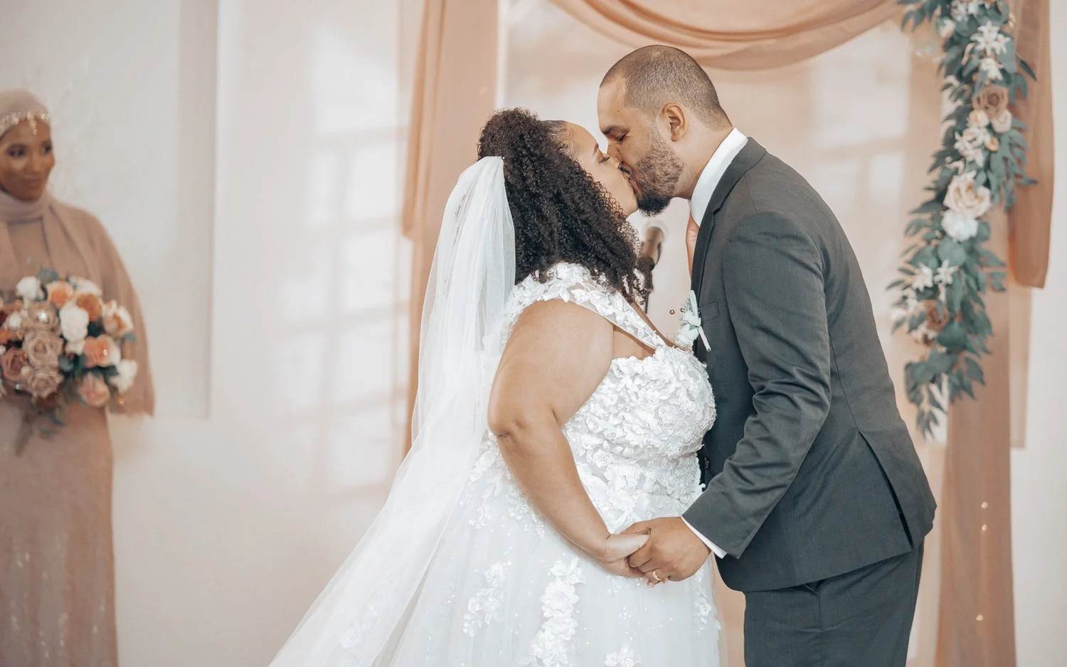 Christina and Erick’s first kiss under their floral arch at The Riverdale