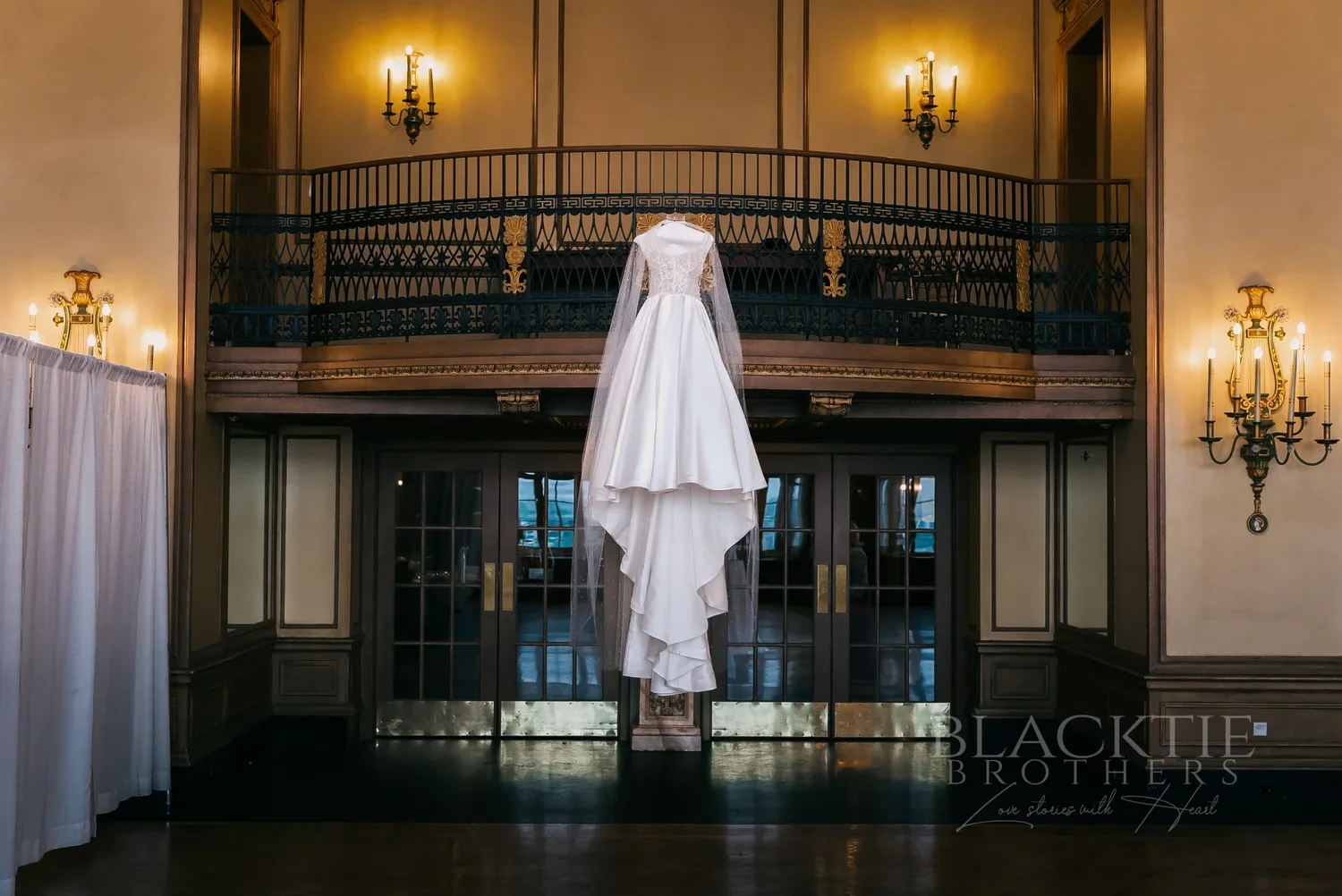 Wedding dress hanging from the mezzanine railing at Marriott Syracuse Downtown