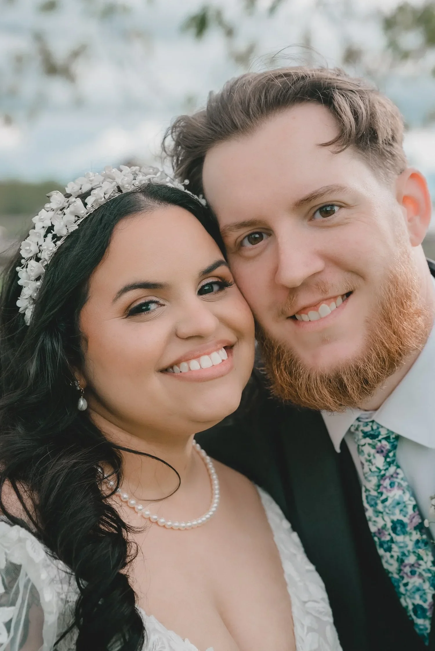 Jessica and Christian cheek to cheek, both smiling, in a close portrait outside at Knotting Hill Farm