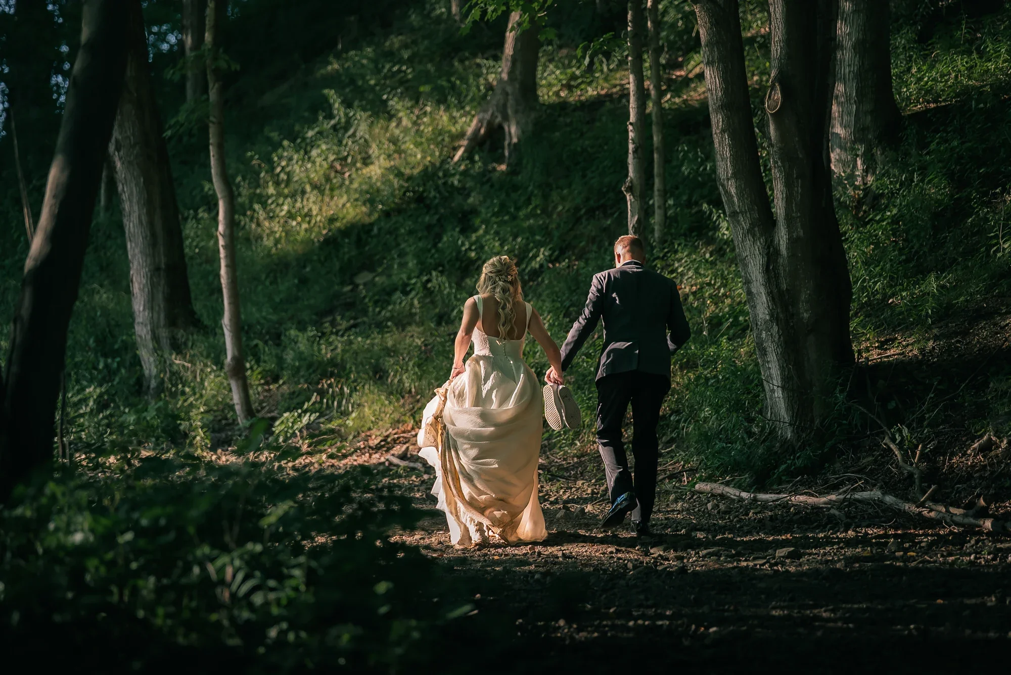 Couple walking a wooded path across the 120 acre LedgeRock grounds.
