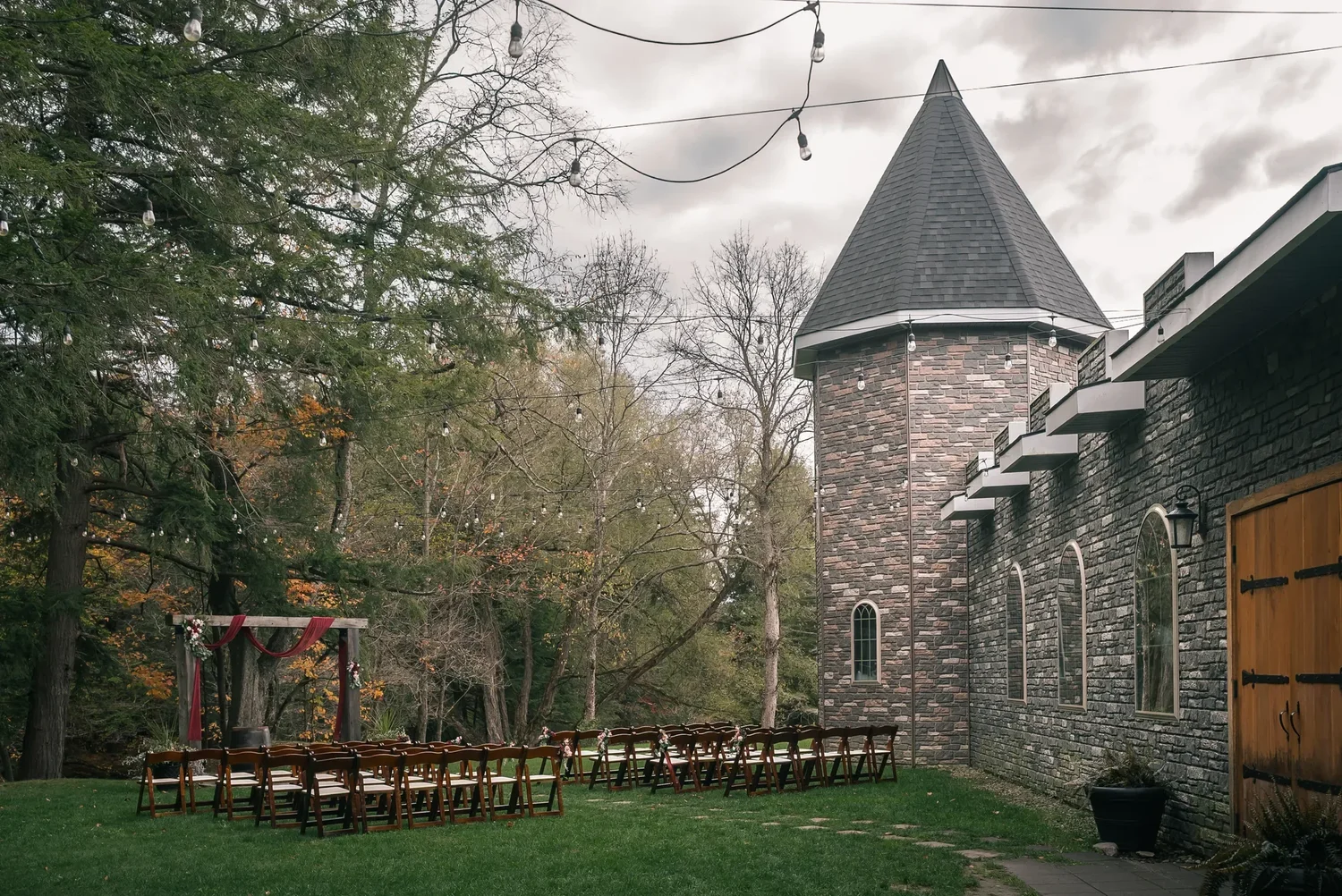 Stone turret and outdoor ceremony setting beside Stoney Creek Castle
