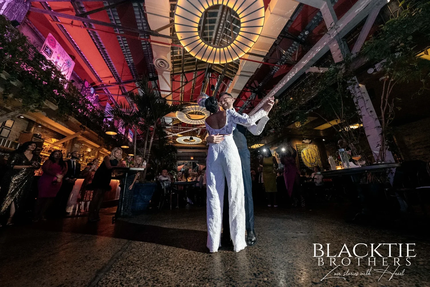 Ciara and Drew's first dance in the middle of Fandi Mata's main room under the skylight and round lamps, guests watching from the tables on every side
