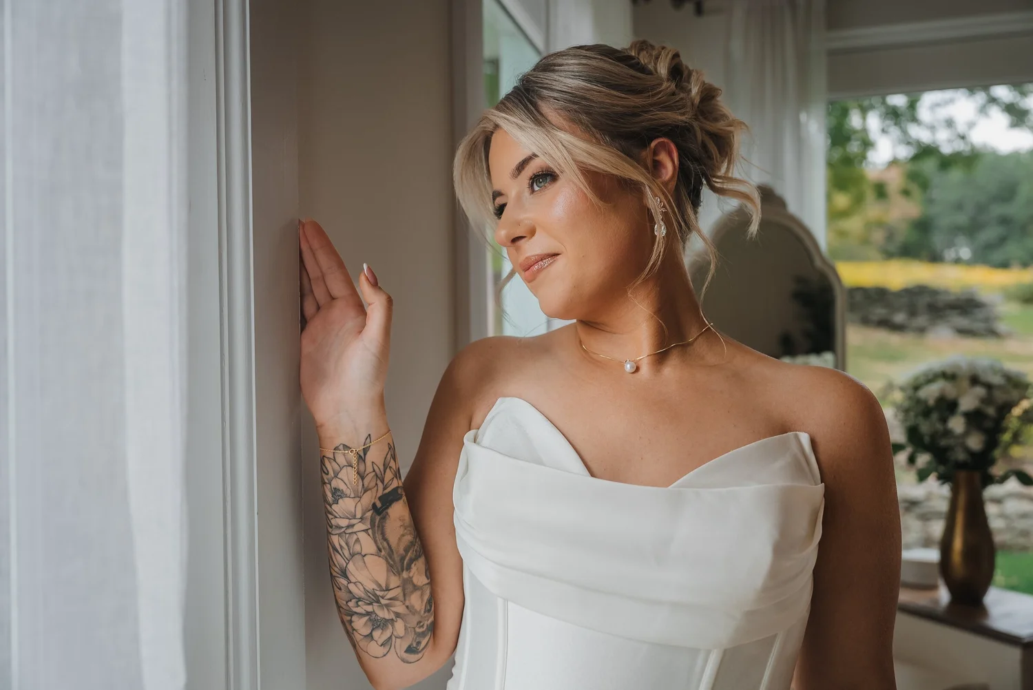 Bride standing in natural window light before her Stonewall Estate ceremony