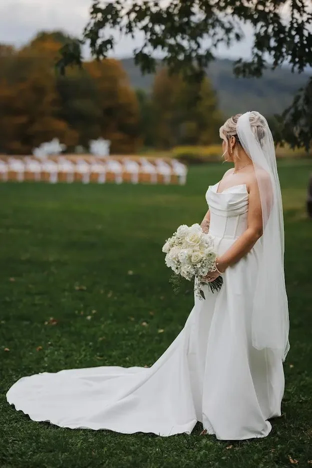 Bride overlooking Stonewall Estate's ceremony chairs and autumn Catskills landscape