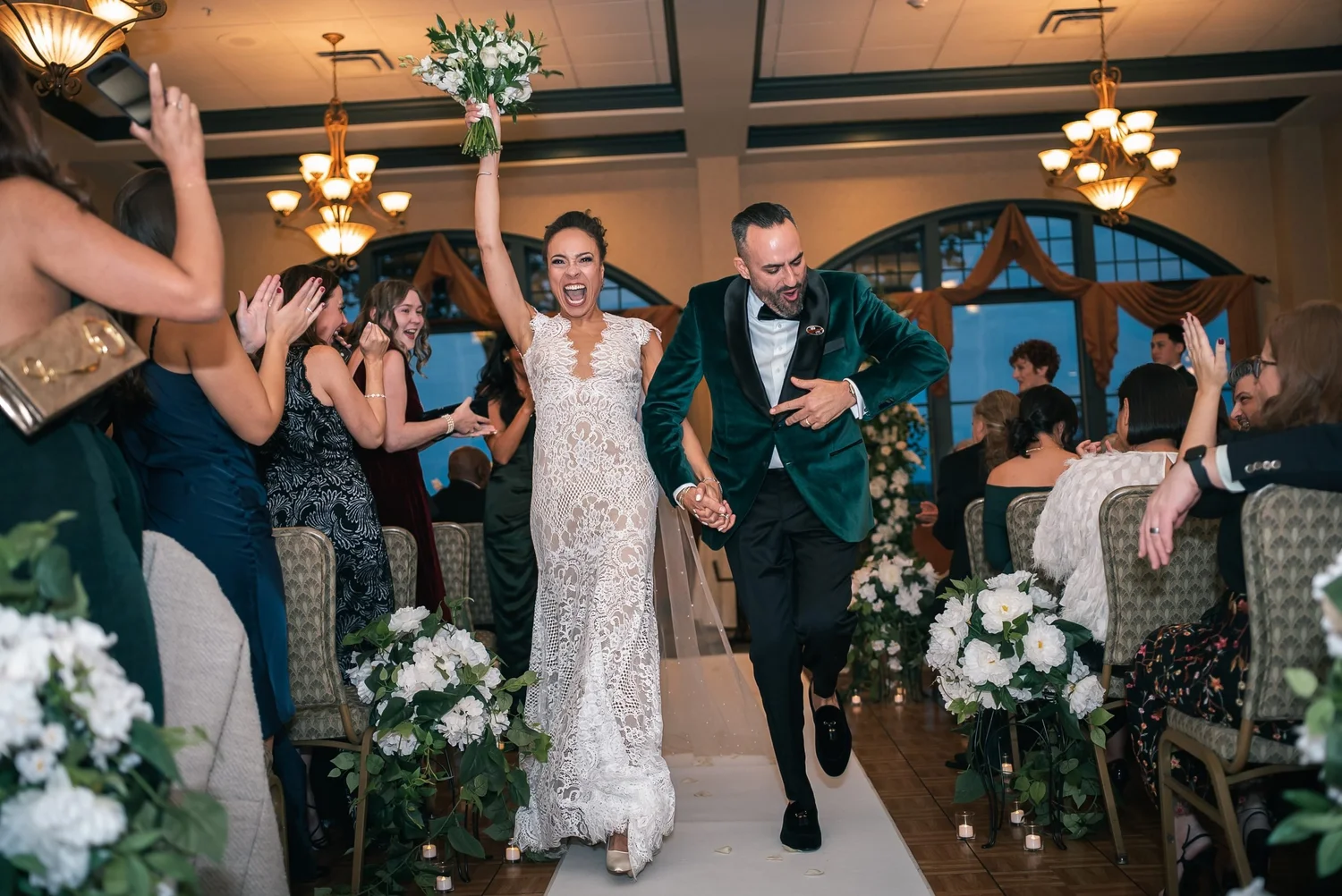 Shannon throws her bouquet in the air and Leon dances beside her as they head back up the aisle, guests cheering on both sides