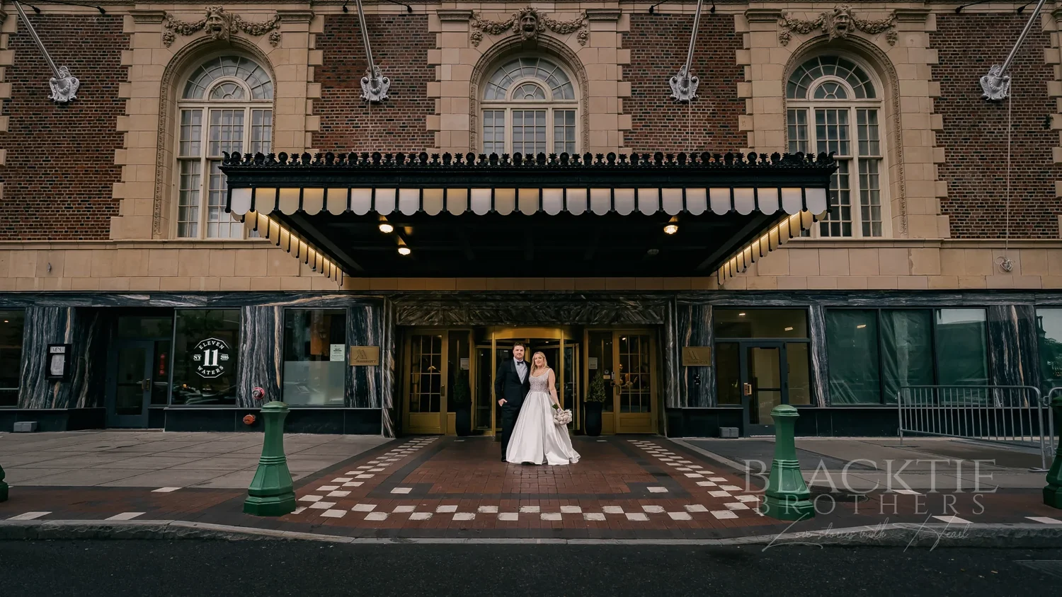Catie and Brad under the Hotel Syracuse marquee in downtown Syracuse