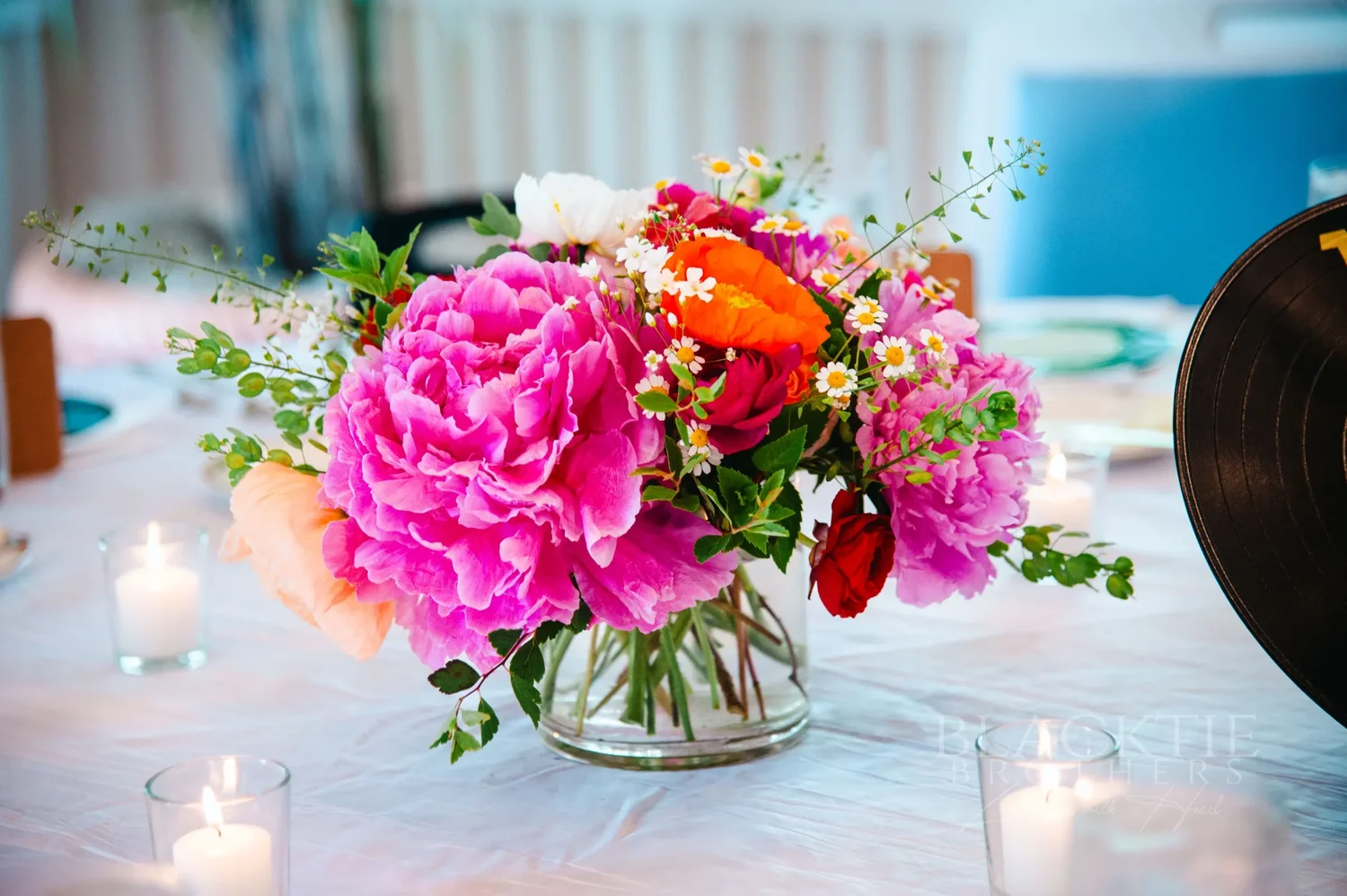Pink peony and rose centerpiece on a reception table at The Otesaga