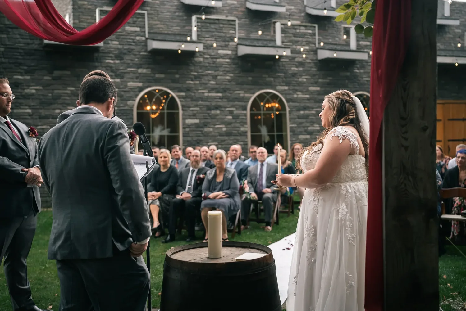 Couple facing one another during an outdoor ceremony at Stoney Creek Castle