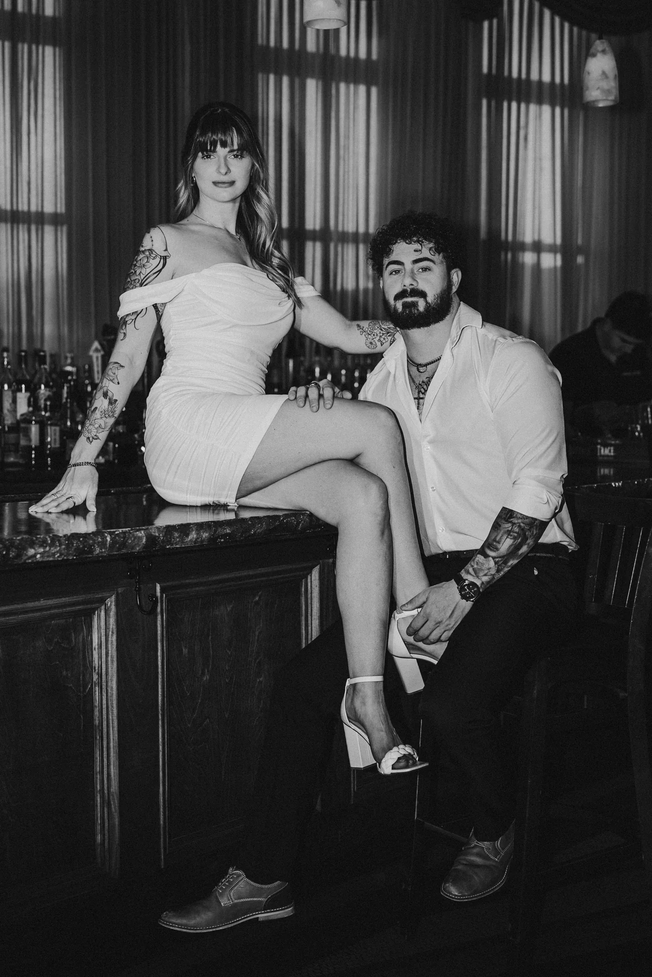 Kari and Josh’s black-and-white engagement portrait at the Remlik’s bar.
