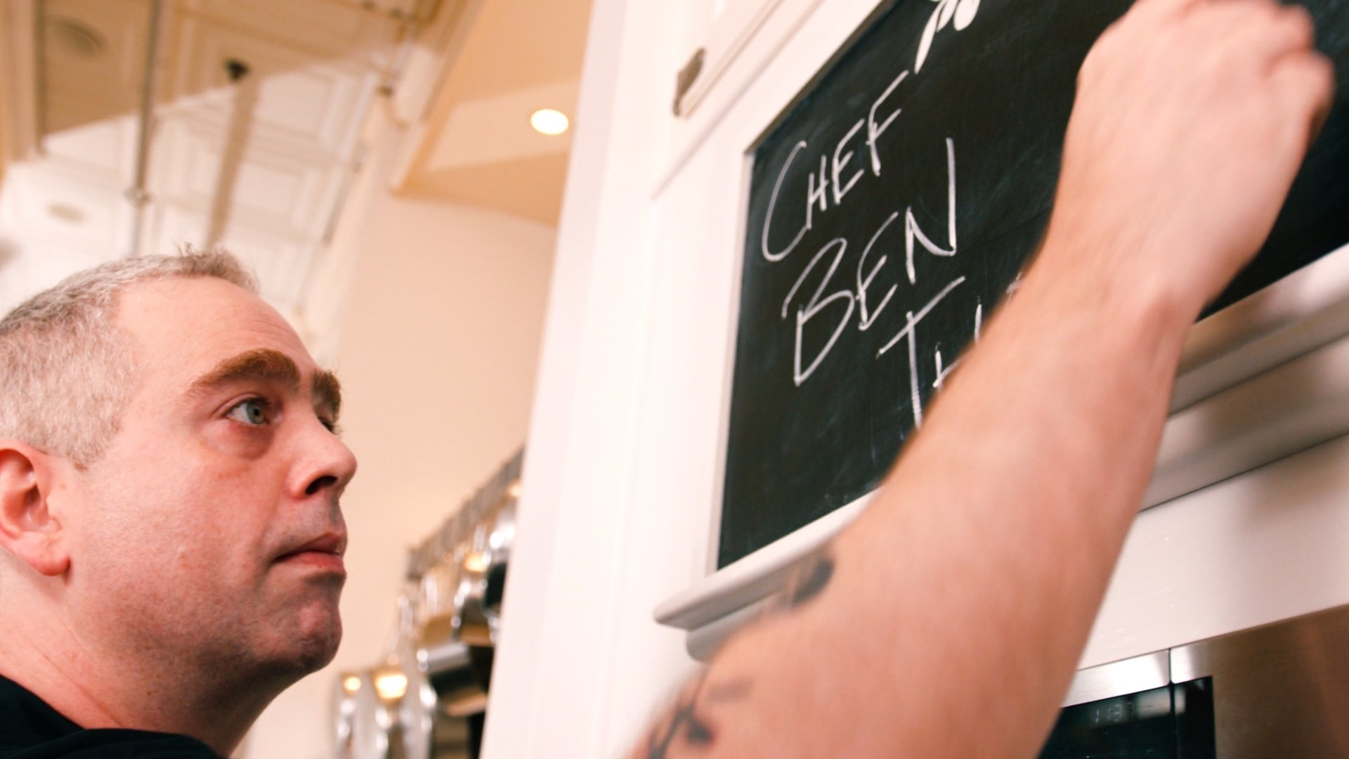person writing on chalkboard